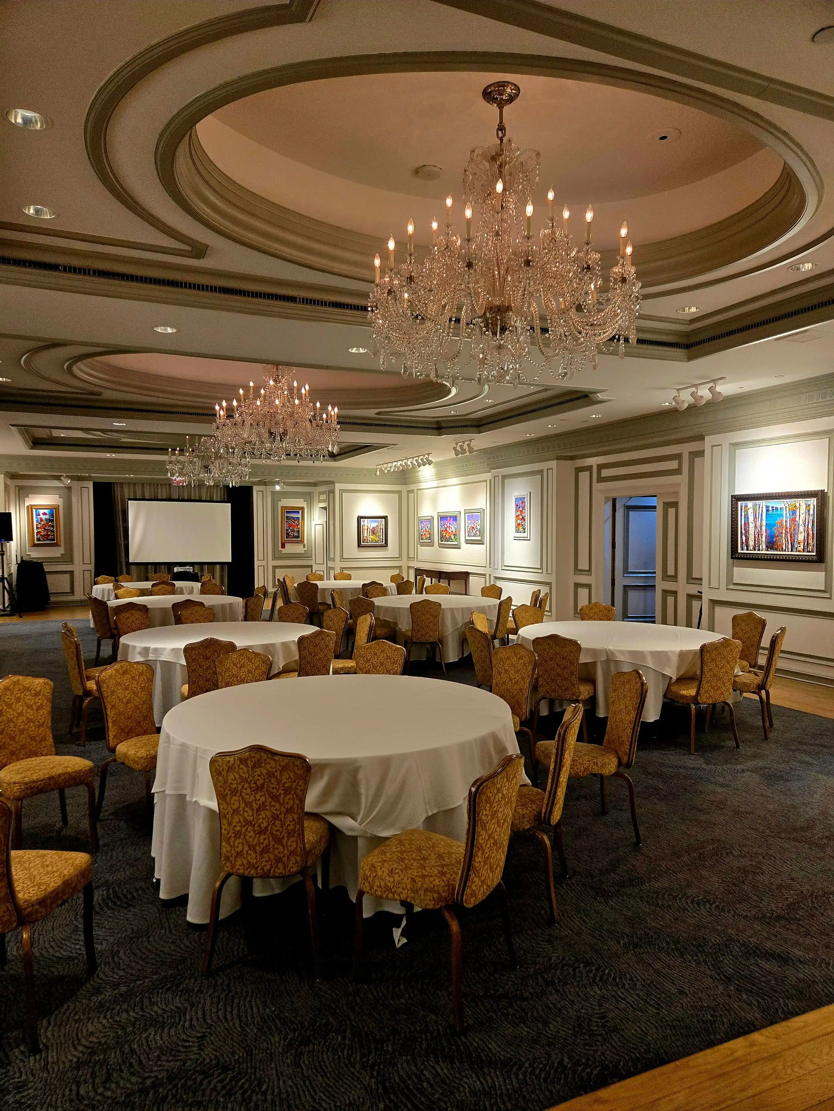 A hotel banquet hall prepared and lit before guests arrive