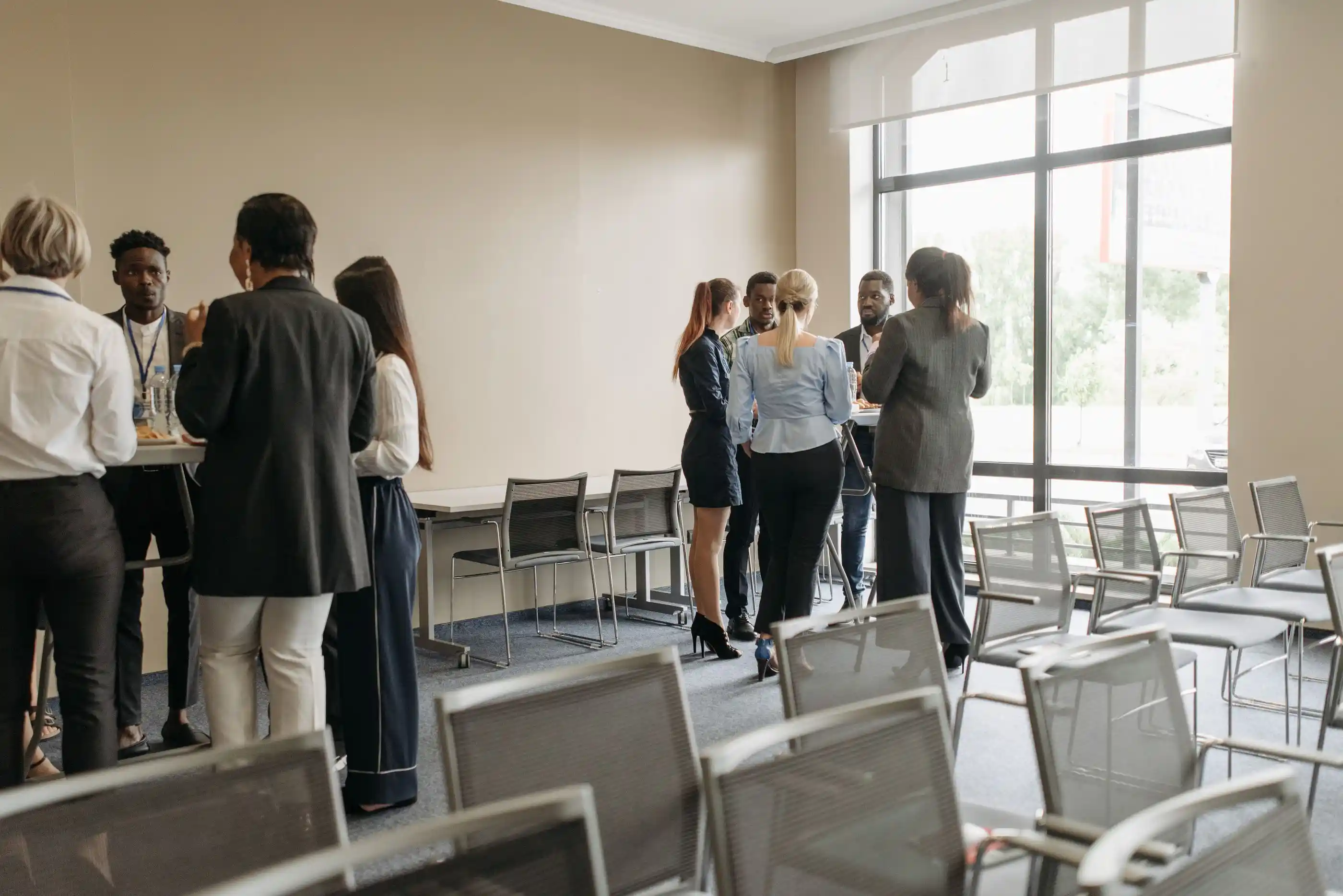 Delegates talking in a bright room during a networking break