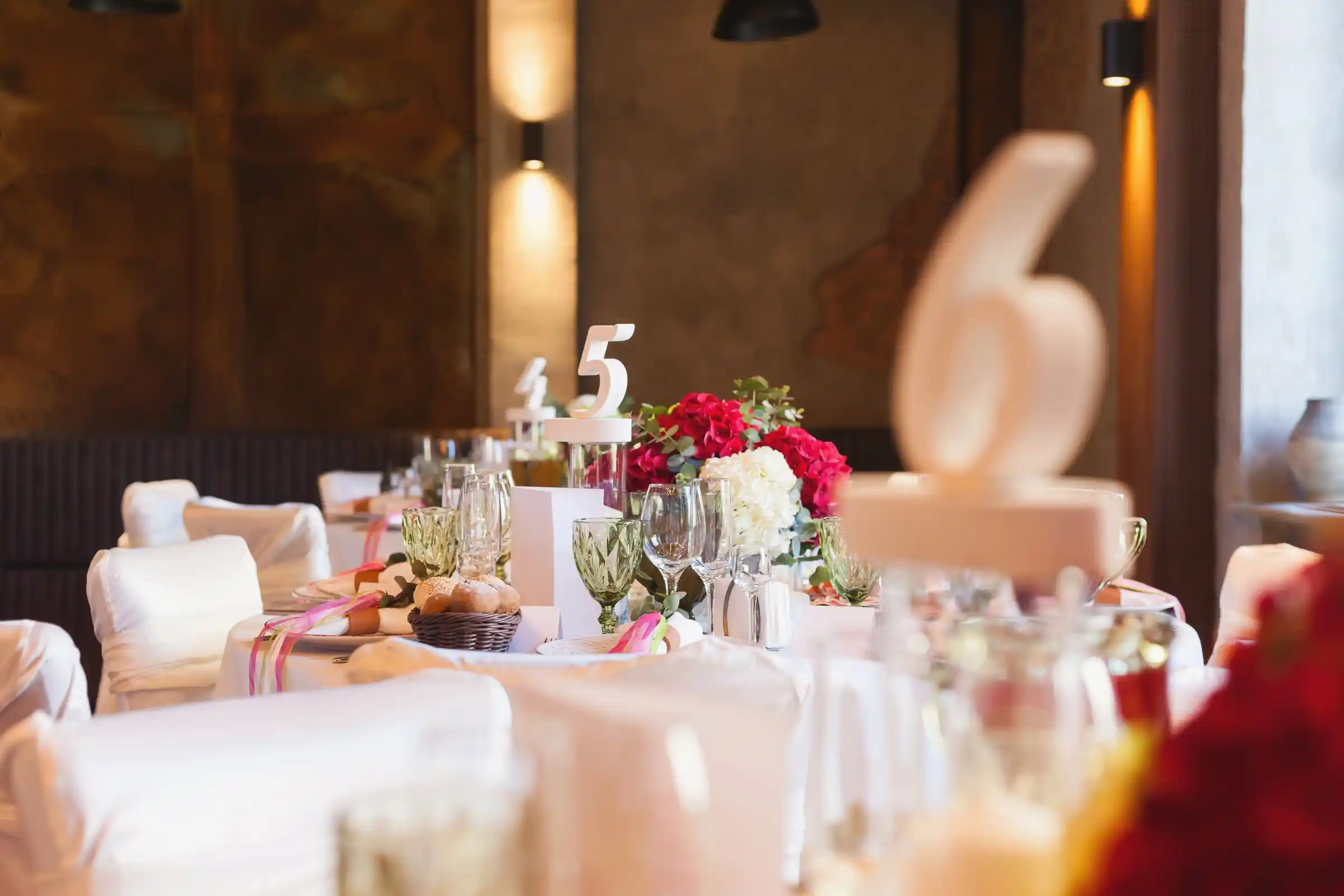 A dessert table dressed with soft florals and pale linen