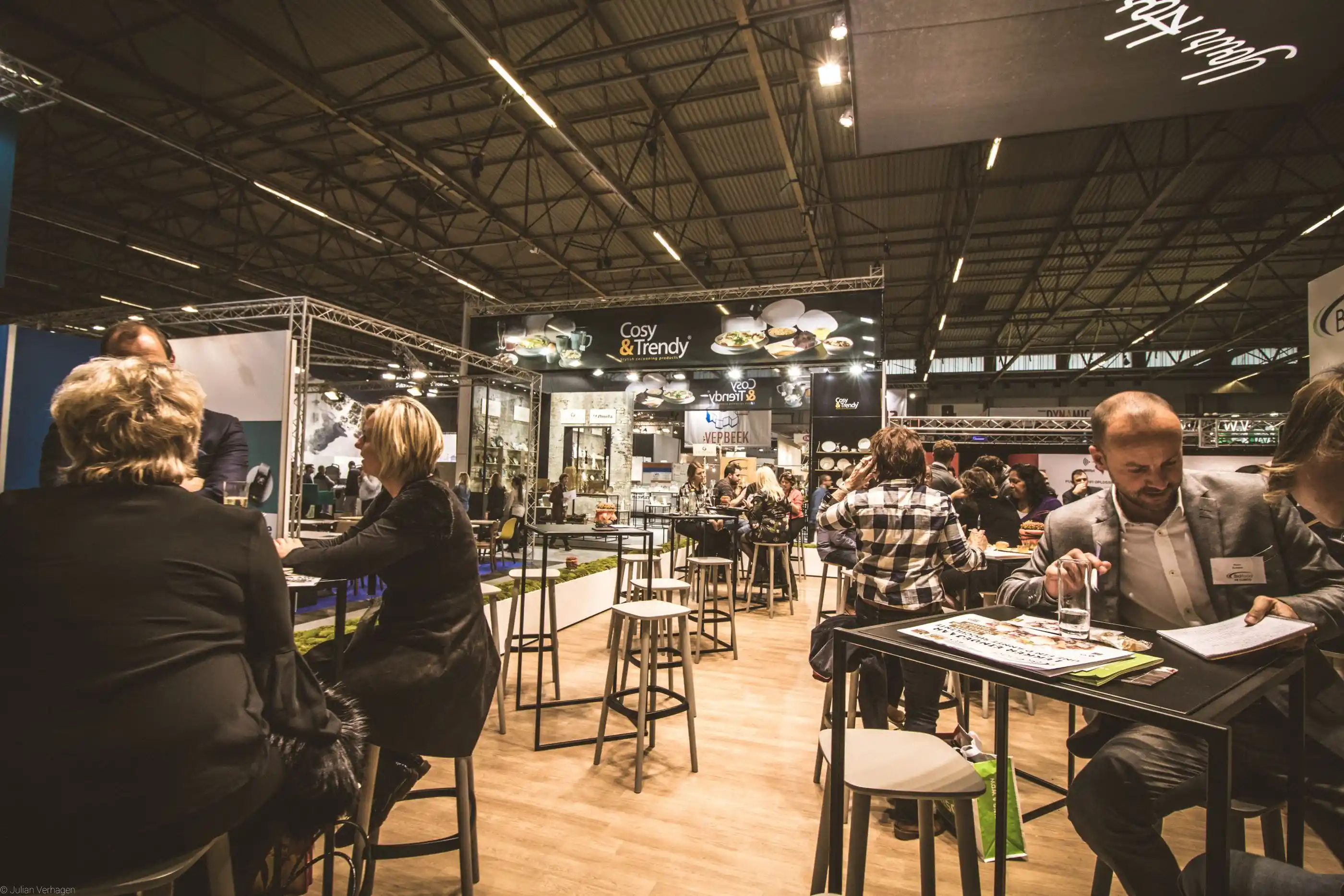Visitors talking around stands at a busy business expo