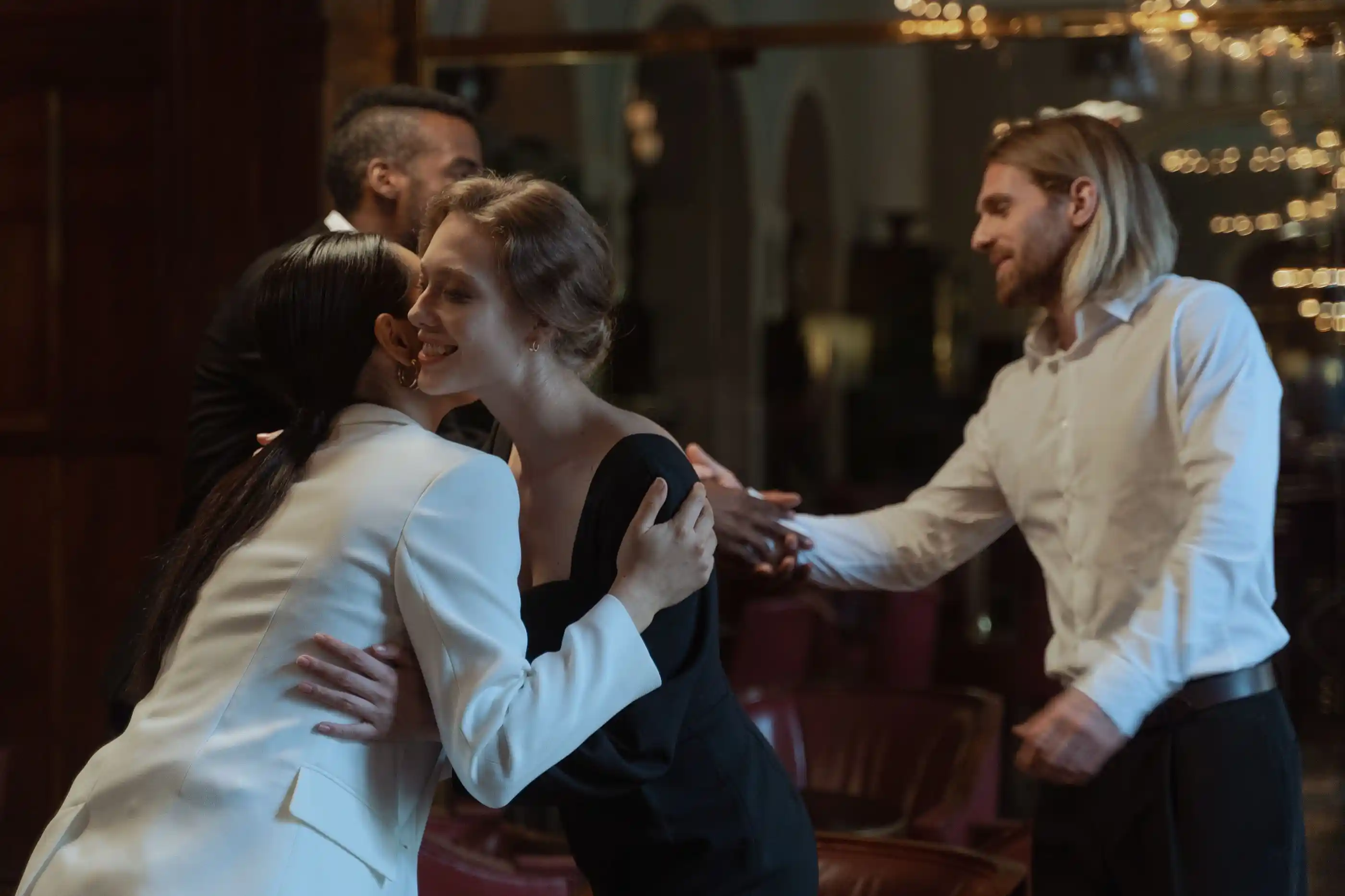 Two guests shaking hands as they arrive at a reception