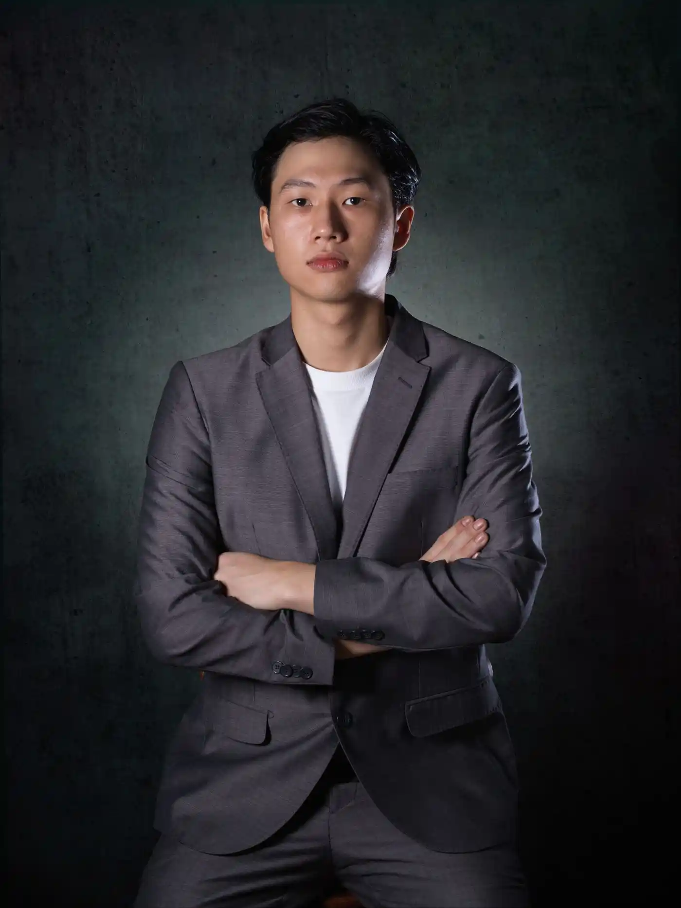Studio portrait of a man in a grey suit