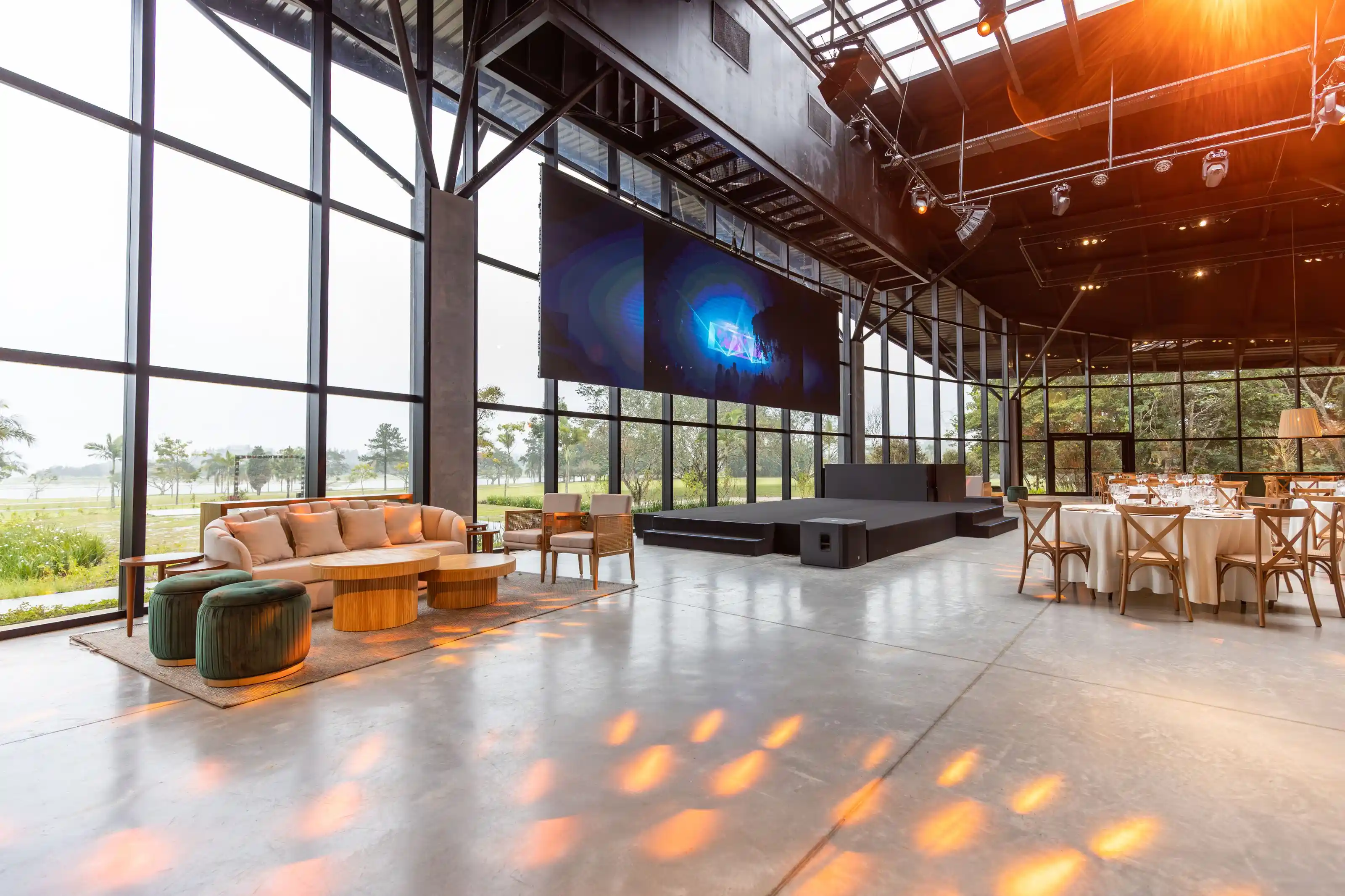 A modern event hall with full-height glazing and open floor