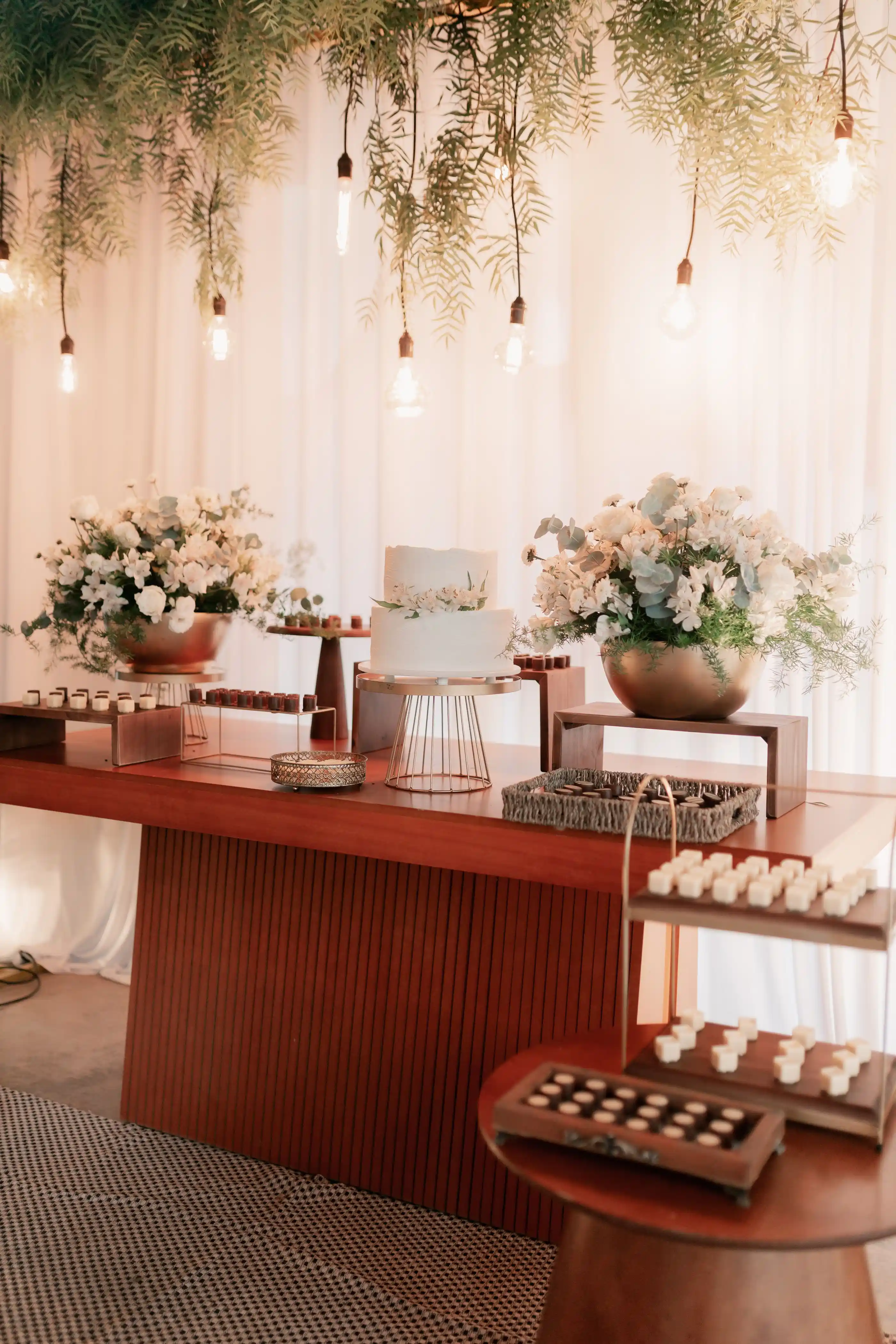 A dressed table with low arrangements and ambient light behind
