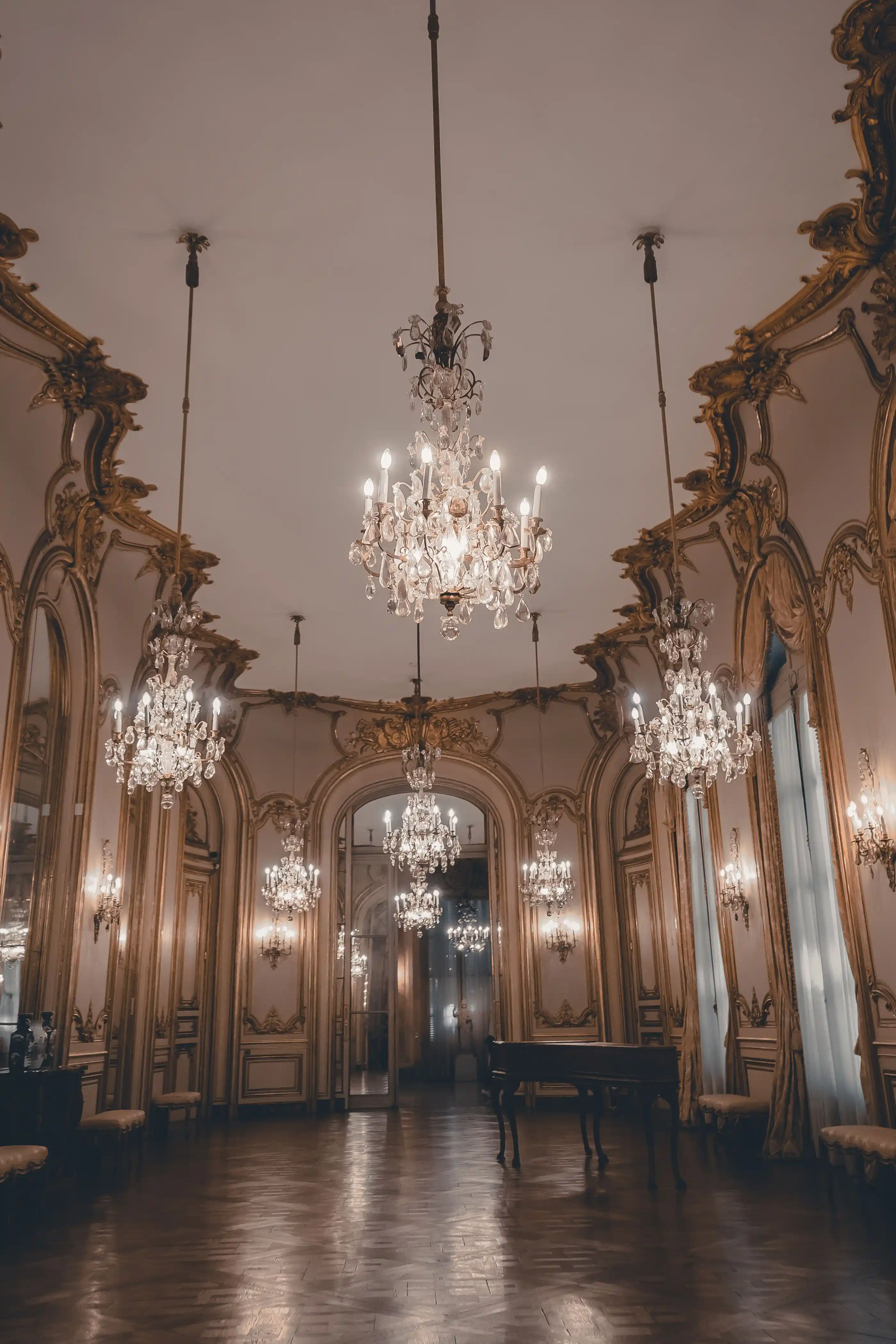 A baroque ballroom with mirrors, gilding and hanging crystal