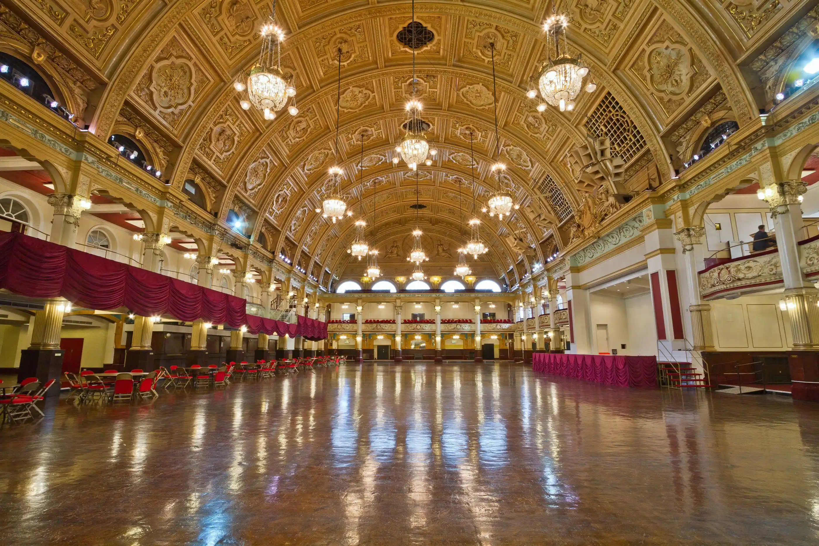 A long historic ballroom with a polished sprung floor