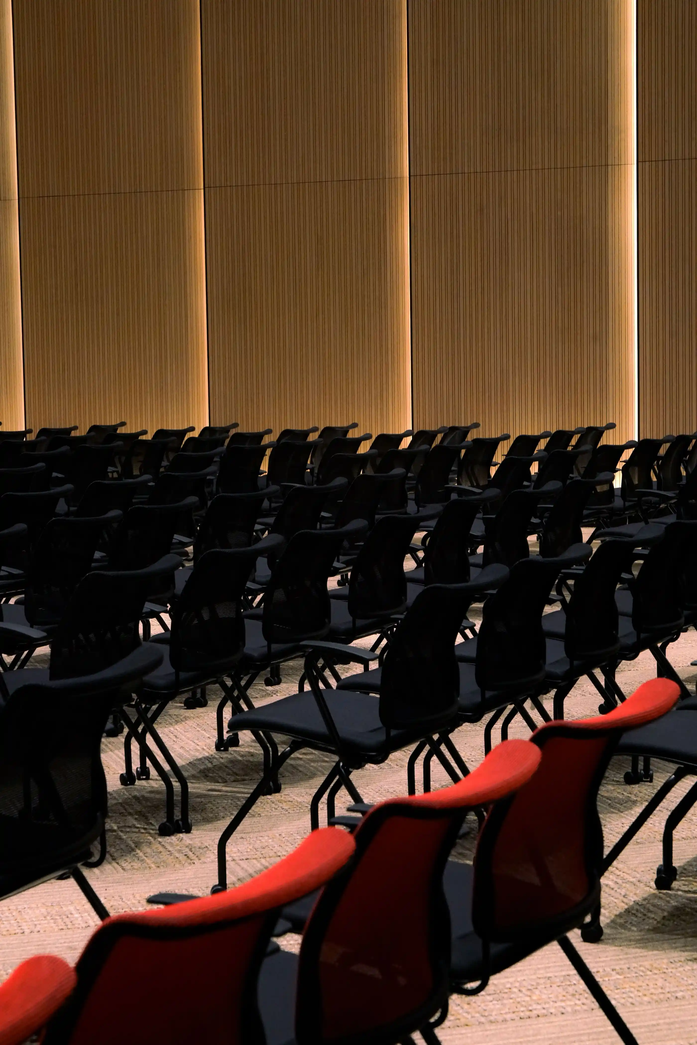 Rows of red and black seating in a convention hall