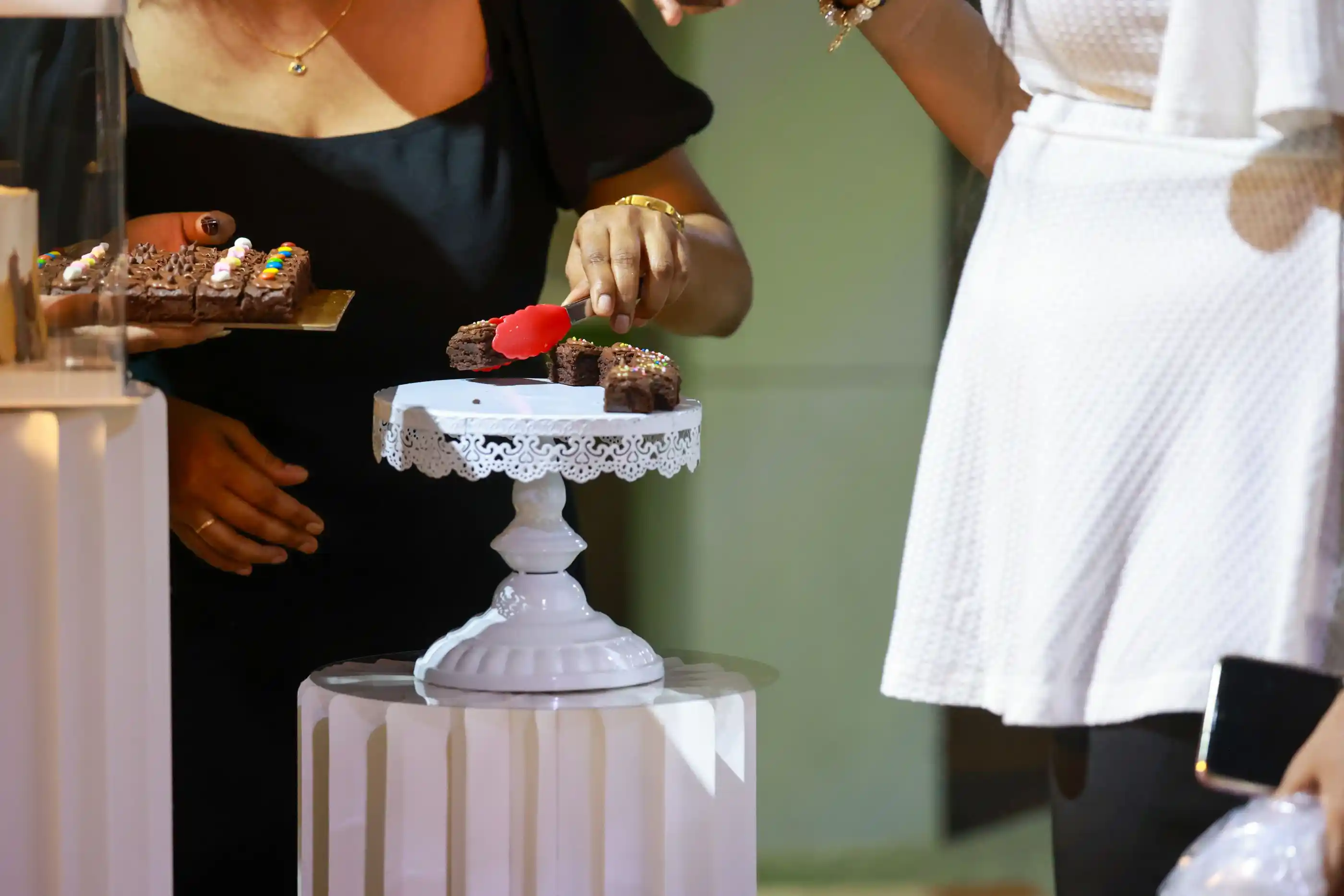 Guests helping themselves at a dessert table
