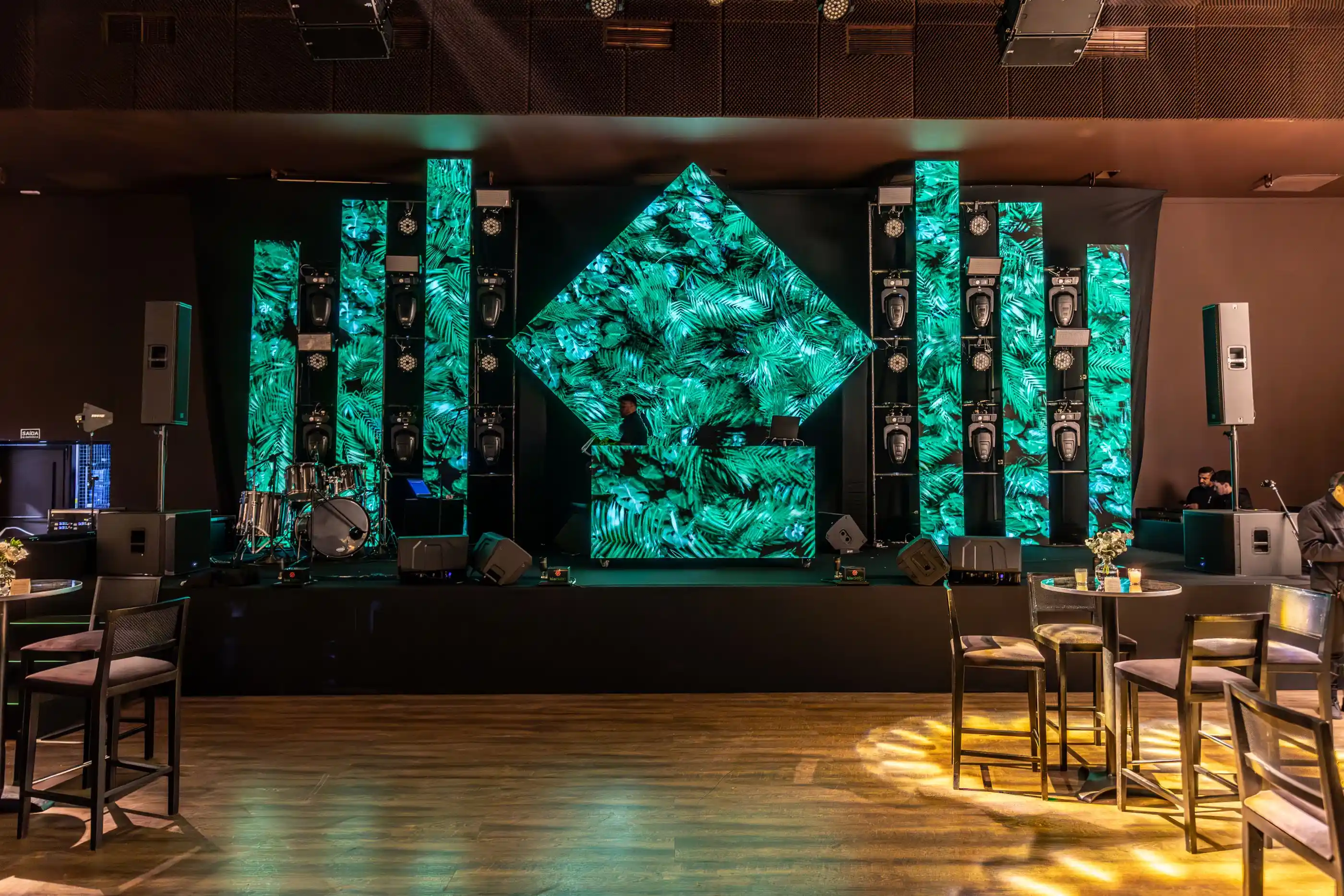 A booth backed by green LED panels in a dark room
