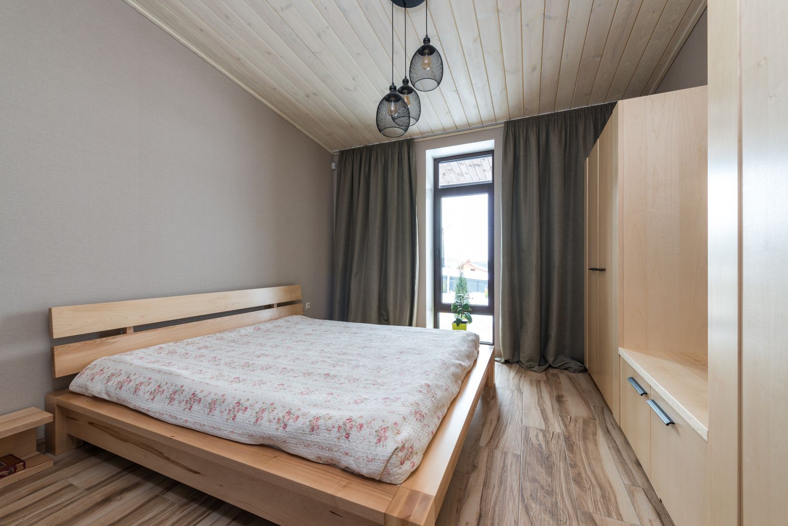Interior render of a cosy timber bedroom beneath a pitched wood ceiling