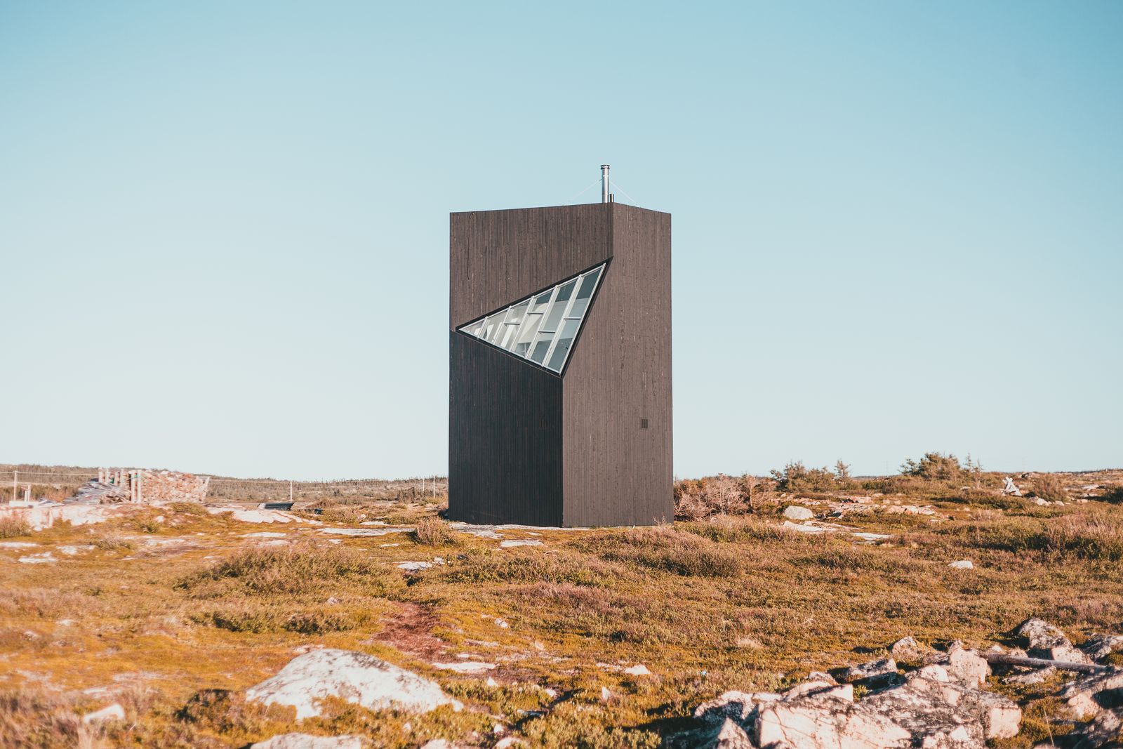 Exterior render — angular blackened pavilion in open moorland