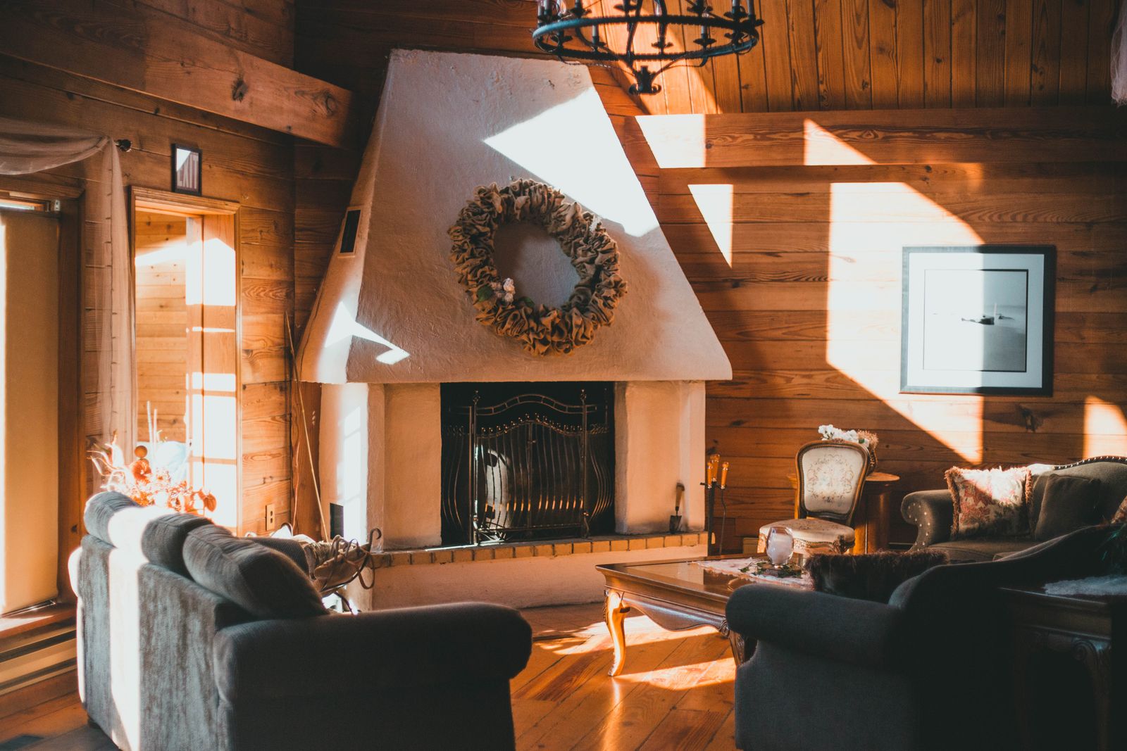 Interior render of a timber-lined living room with a stone fireplace and pitched ceiling