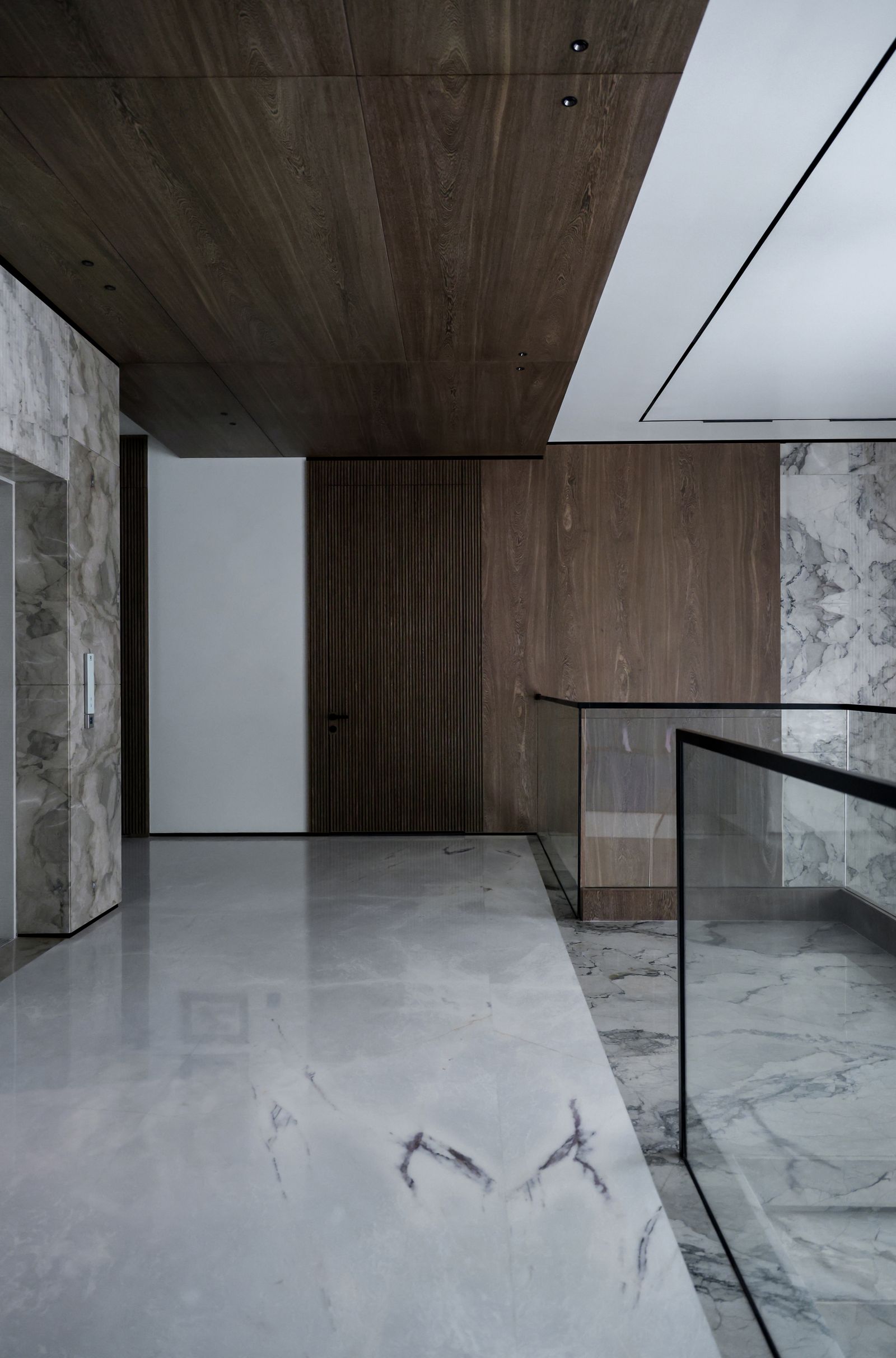Interior render — a calm marble-and-oak stair hall