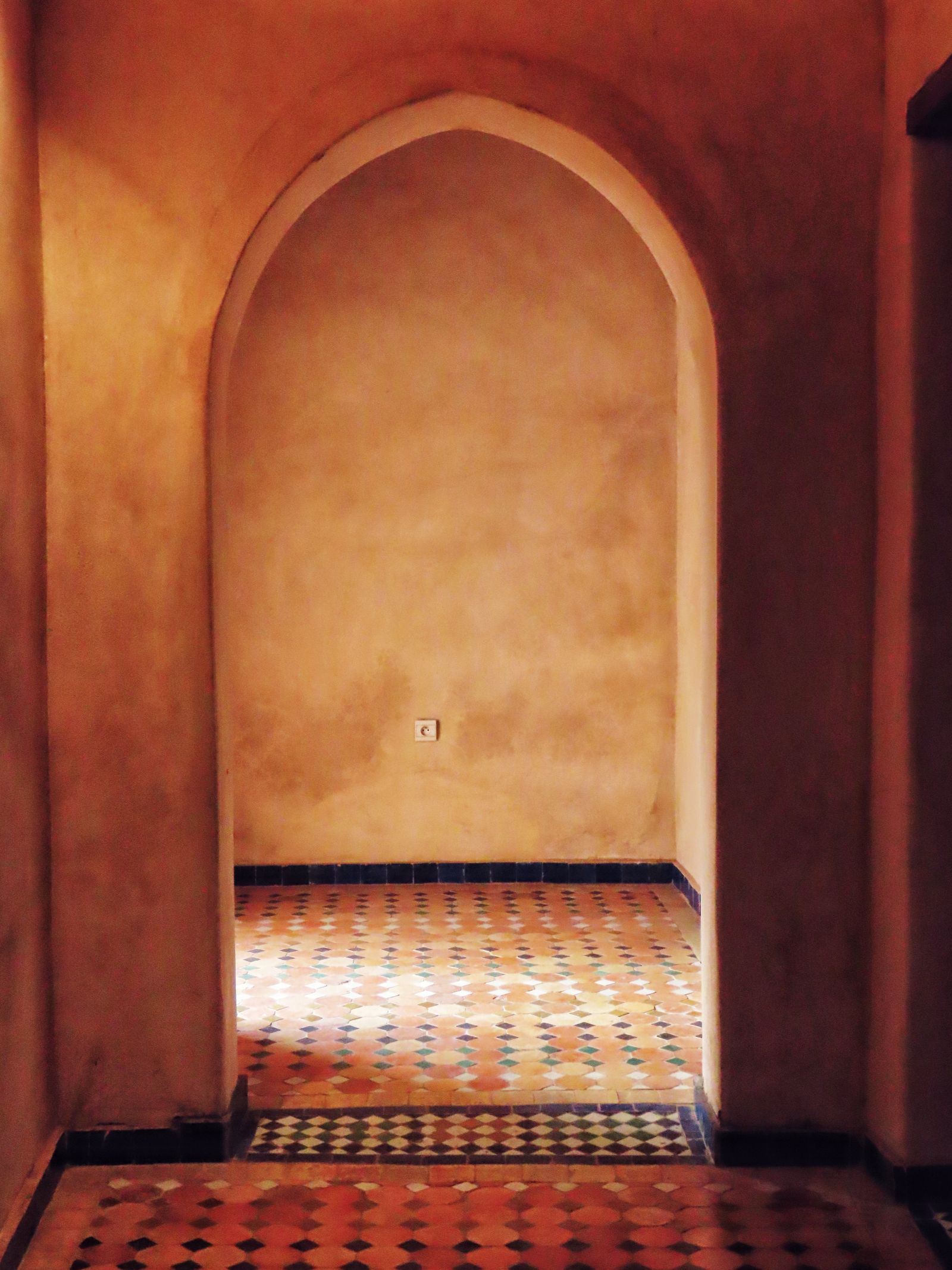 Interior render — warm terracotta arched niche with a tiled floor