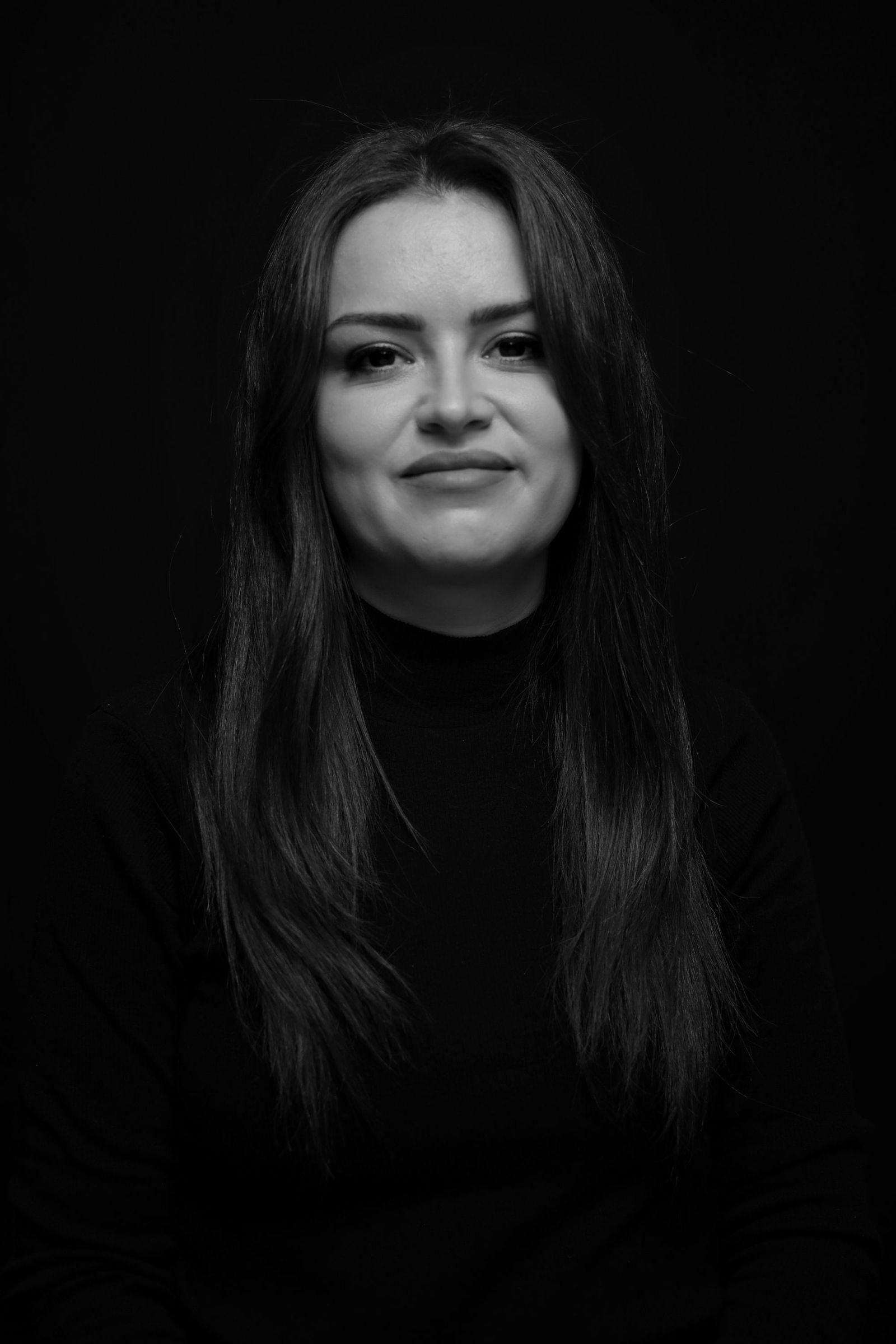 Studio portrait against a dark ground, level with the lens