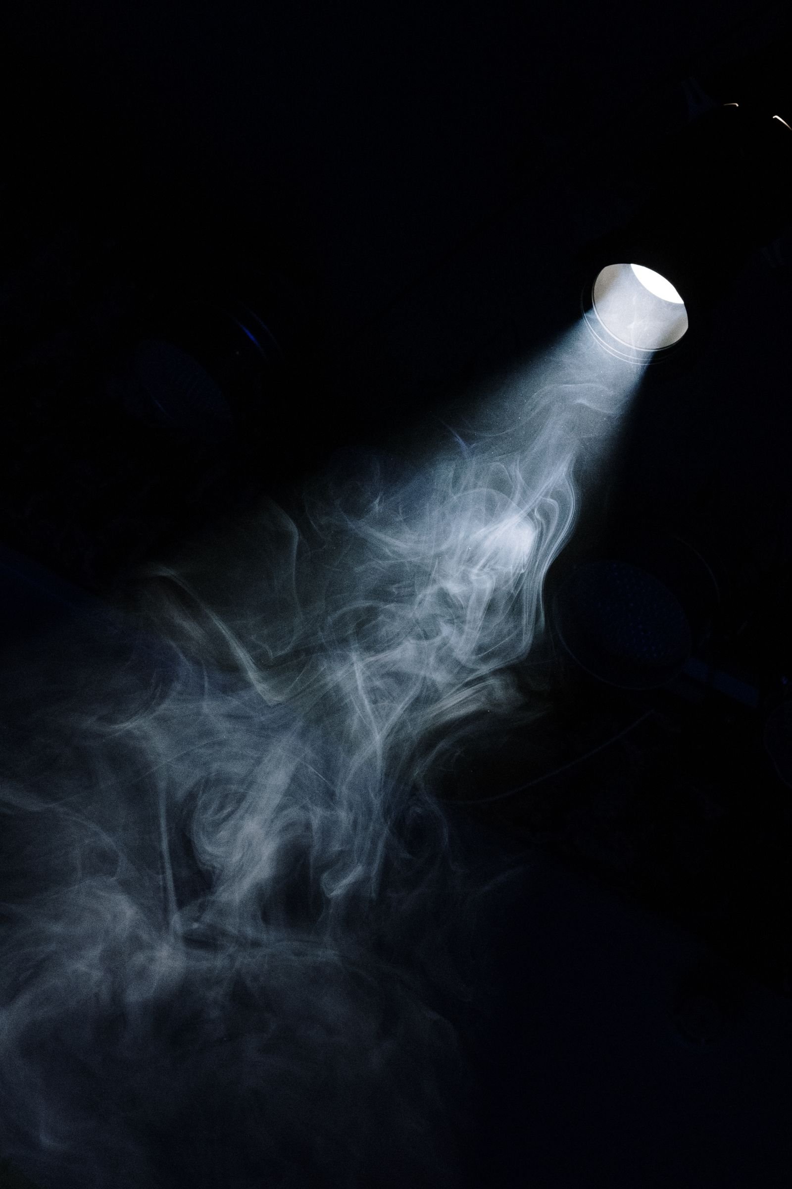 A hard beam of light cutting through drifting smoke