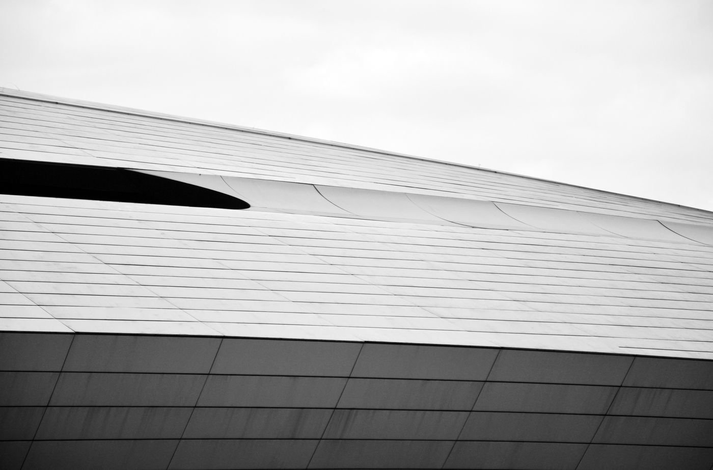 A long horizontal building facade under an overcast sky