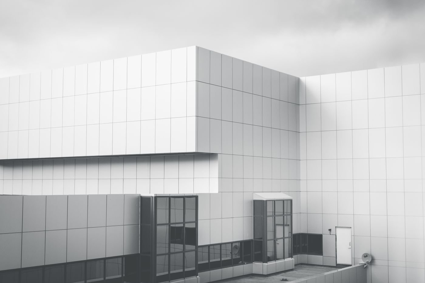 A white panelled modernist facade under an overcast sky