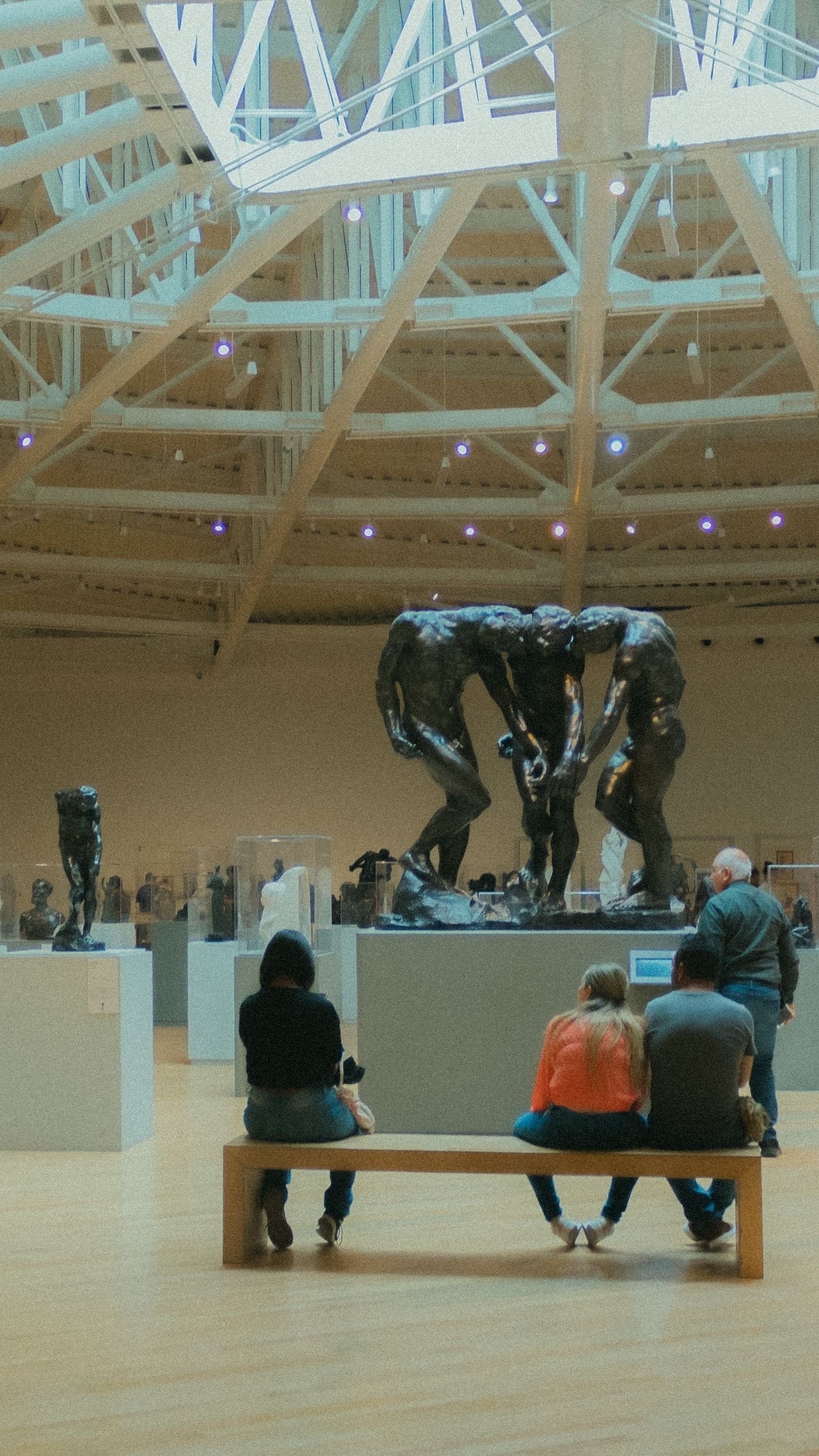 Visitors moving through a high, light-filled gallery