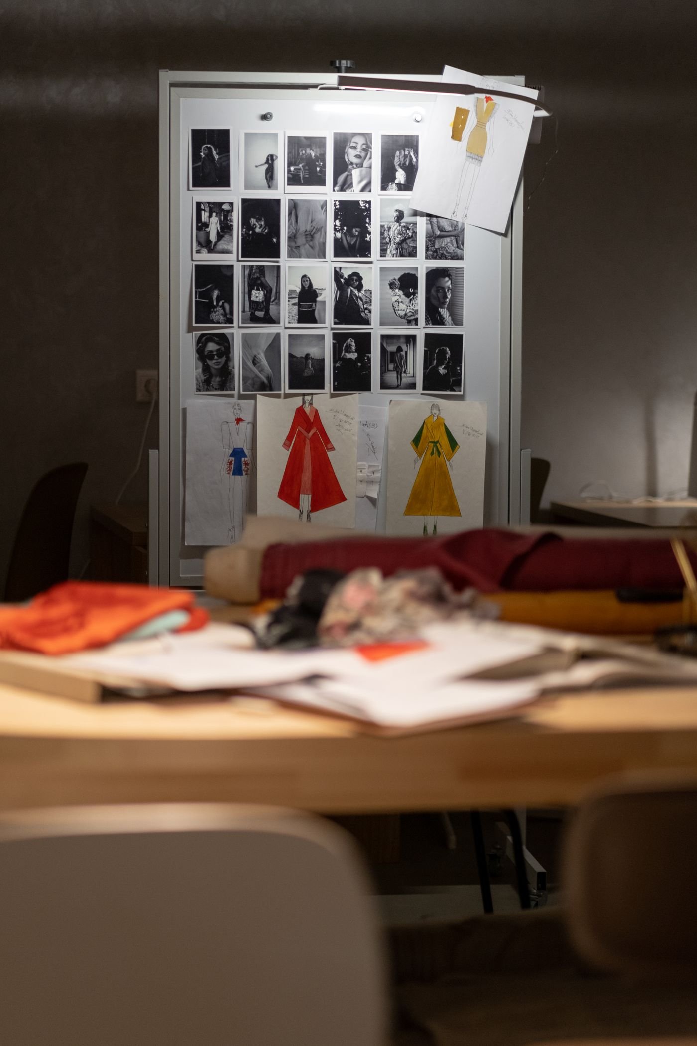 A studio wall pinned with sketches, swatches and references