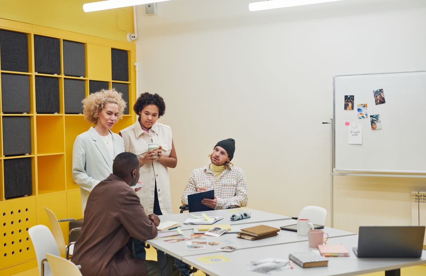 A group working around a table in a bright meeting room