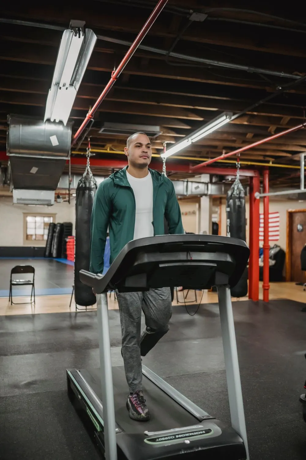 Trainer walking a client through a treadmill session