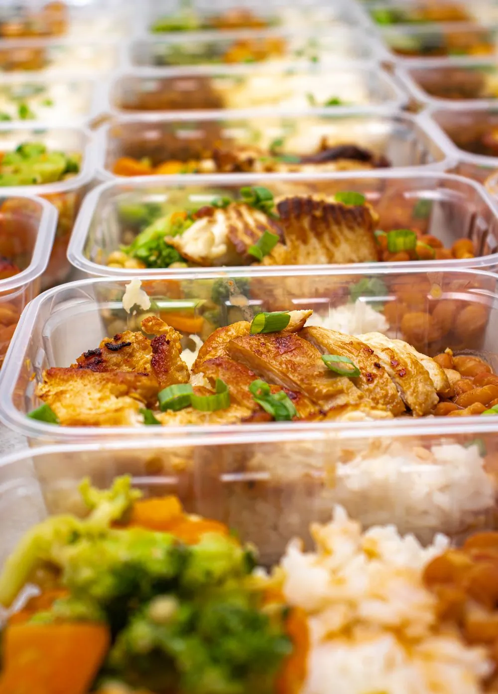 Meal prep containers of grilled chicken, rice and vegetables