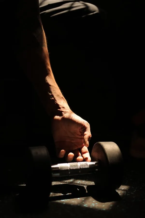 Hand gripping a dumbbell