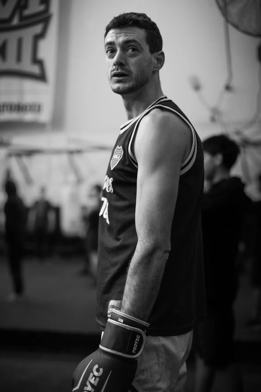 Black and white portrait of a boxer wrapping his hands