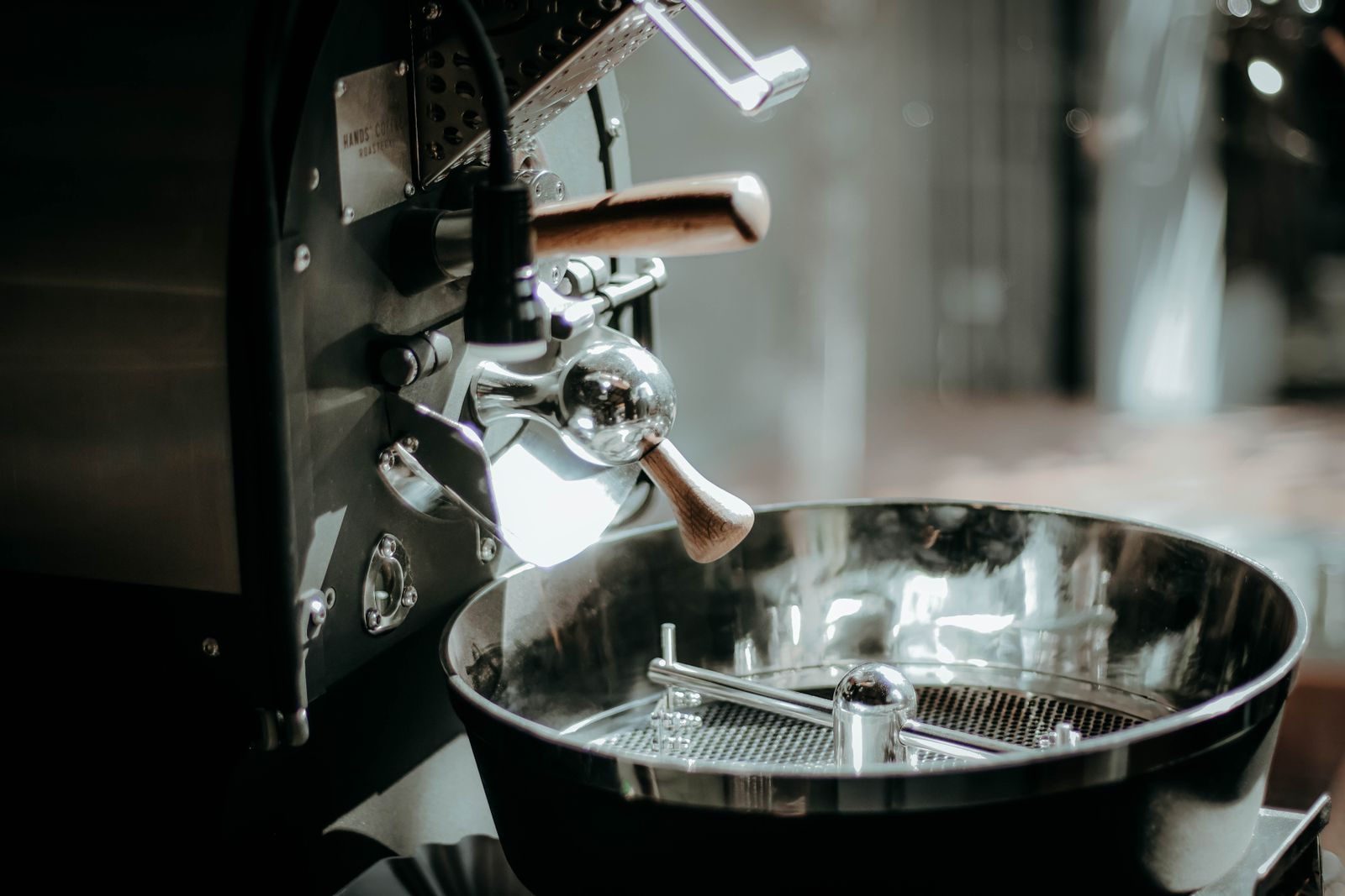 Stainless commercial coffee roaster cooling tray in low light