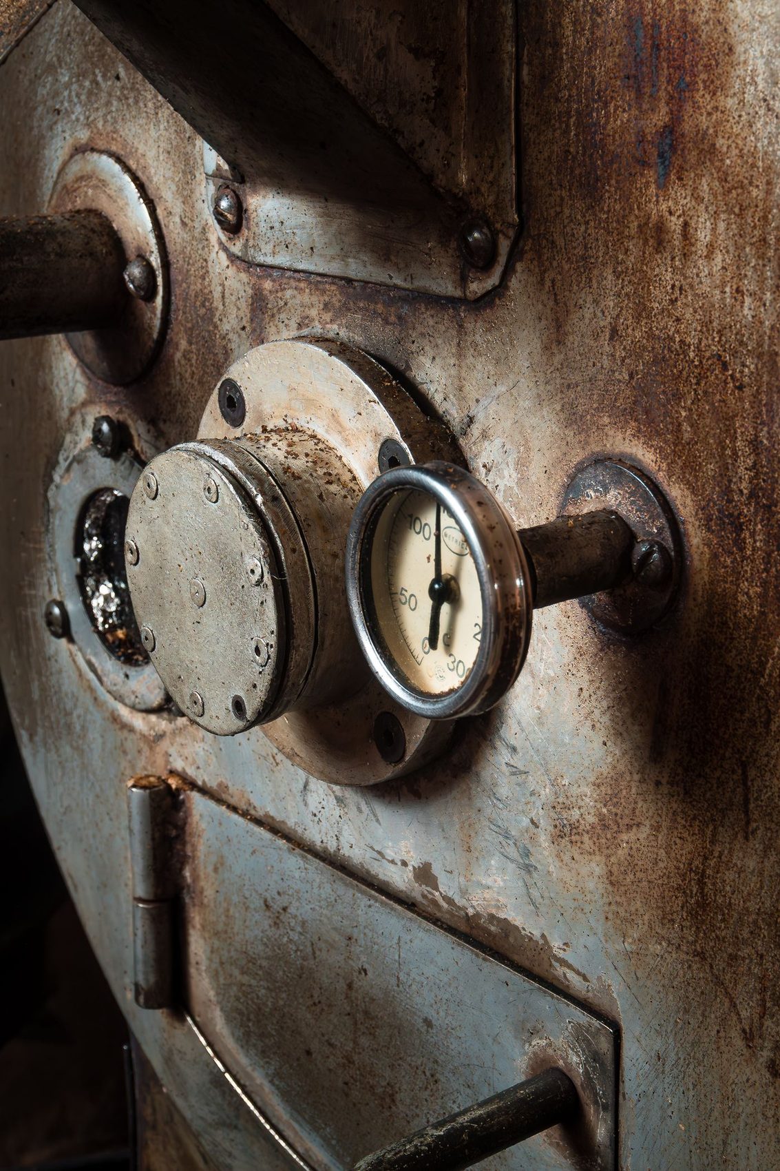 Close-up of a coffee roaster control gauge and drum