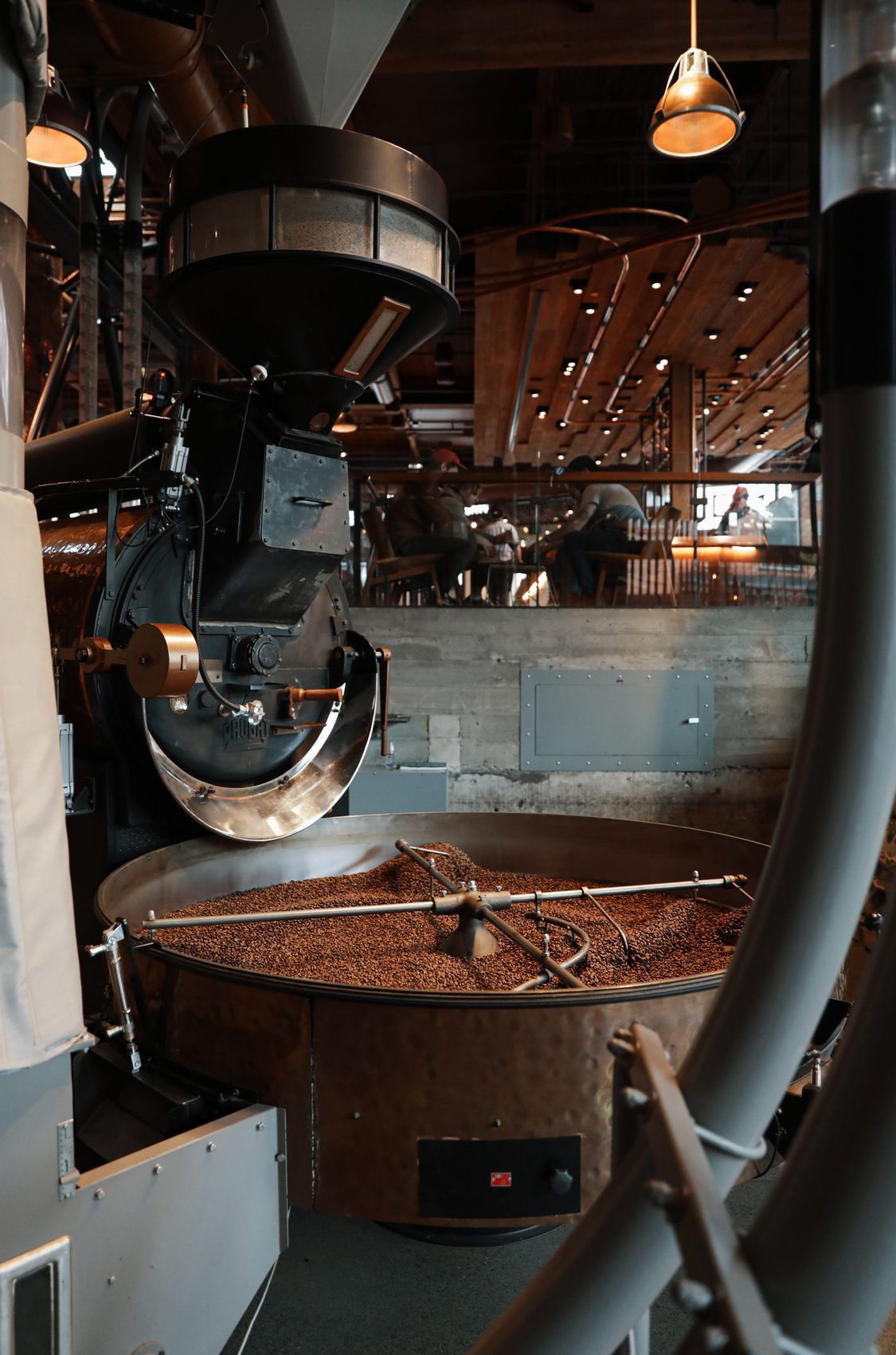 Interior of the Kaldera roastery workshop with a drum roaster