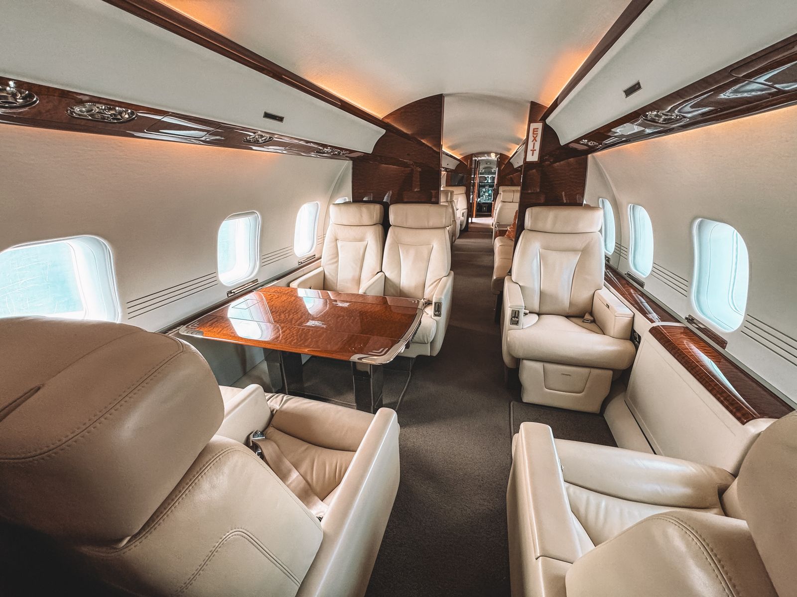 The leather-and-wood interior cabin of a private aircraft