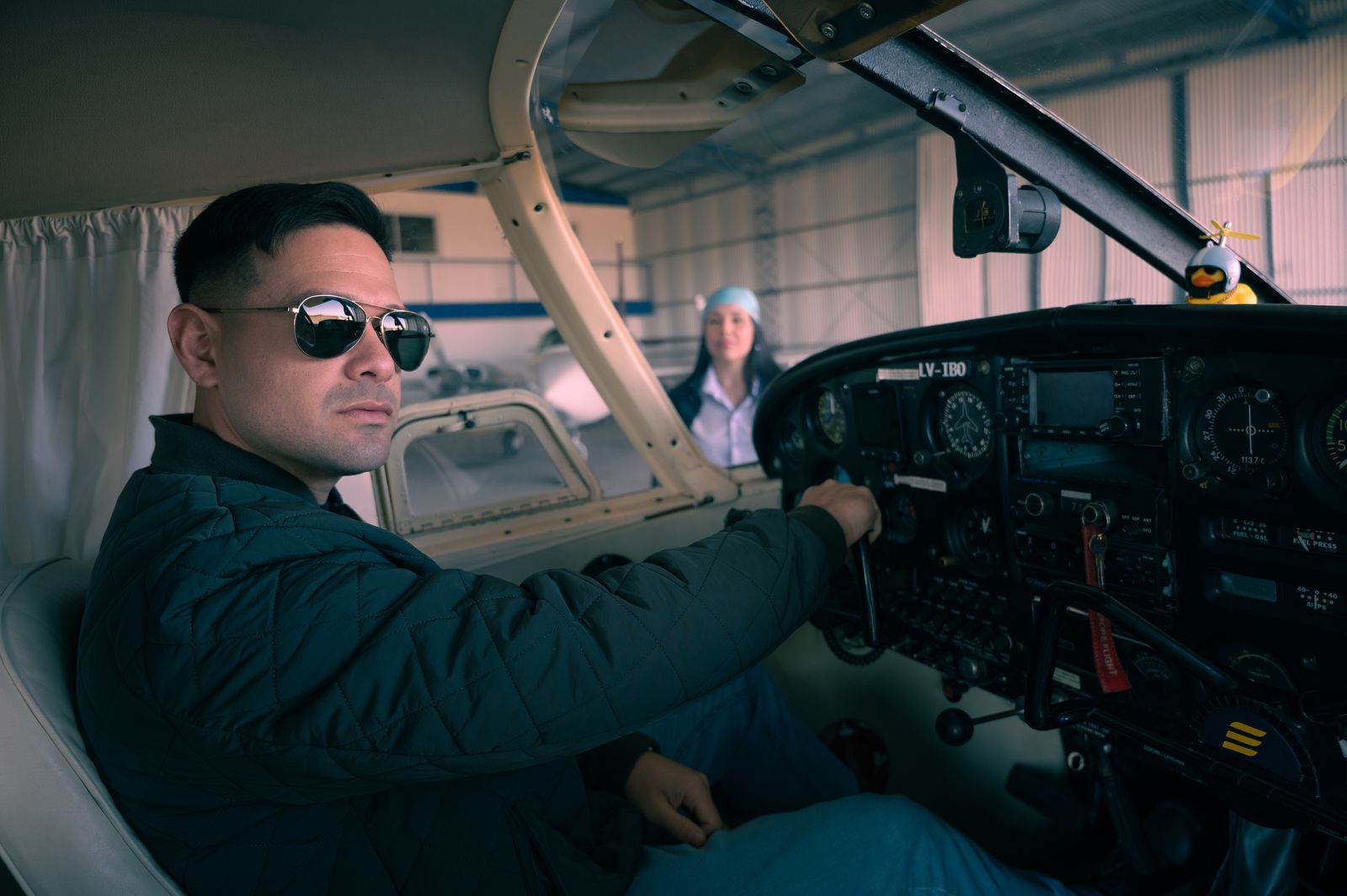 A pilot seated at the controls of a light aircraft