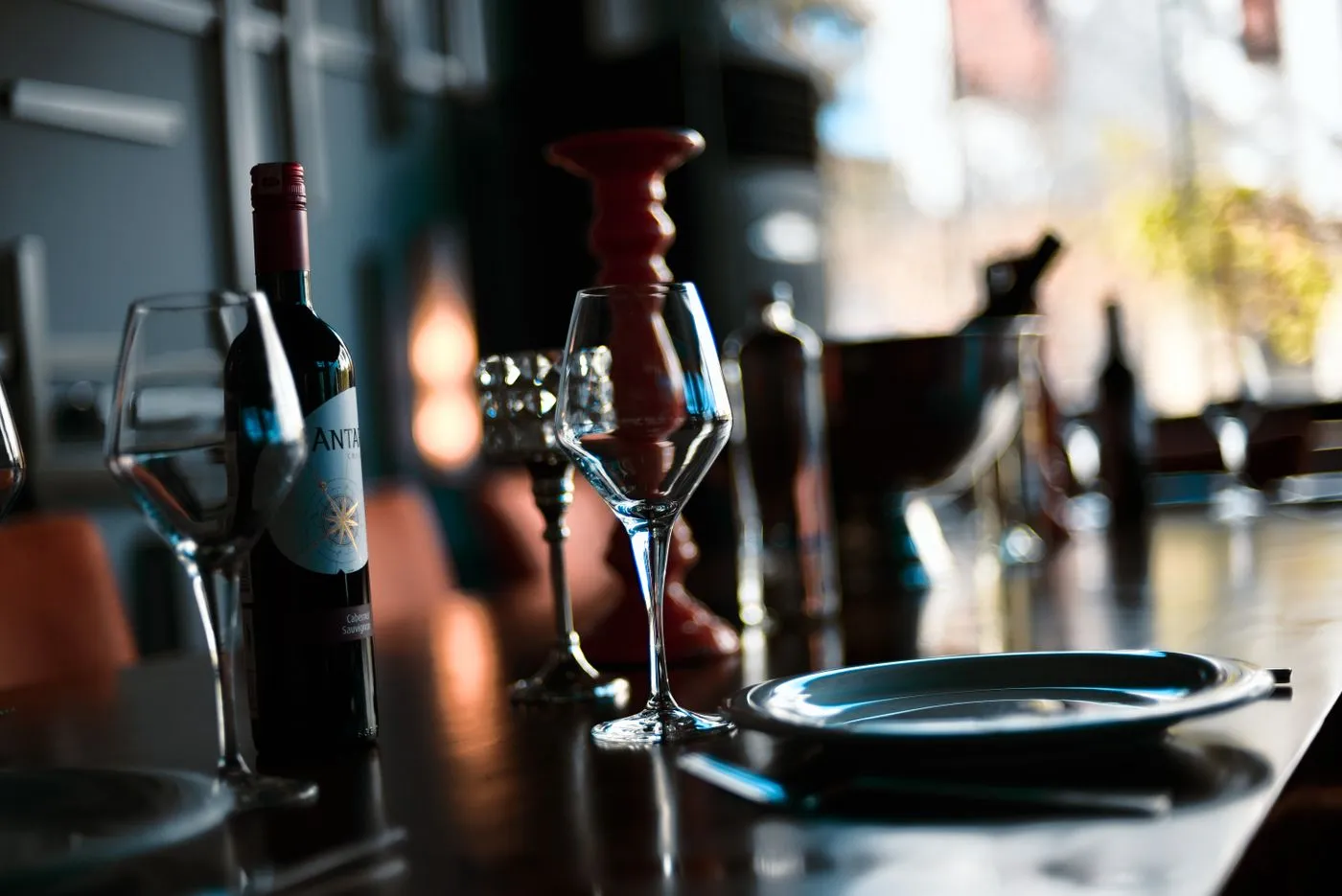 Wine glasses and a bottle on a wooden table