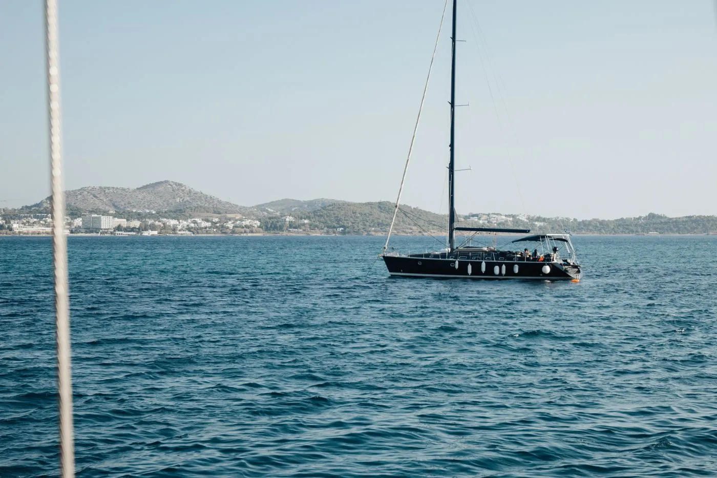 Motor yacht on blue water with a distant coastline