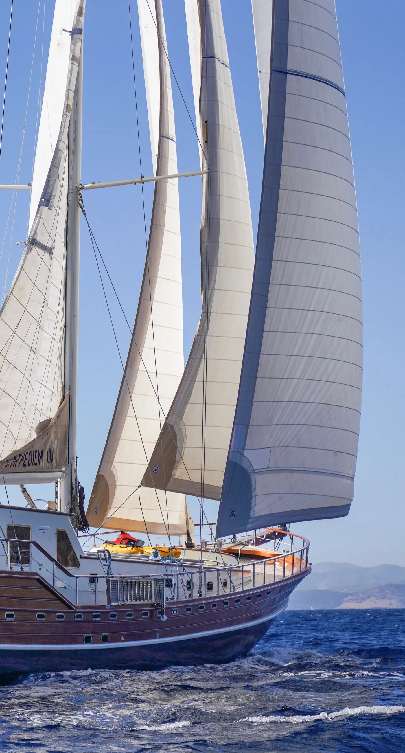 Sailing yacht with full sails on a clear day