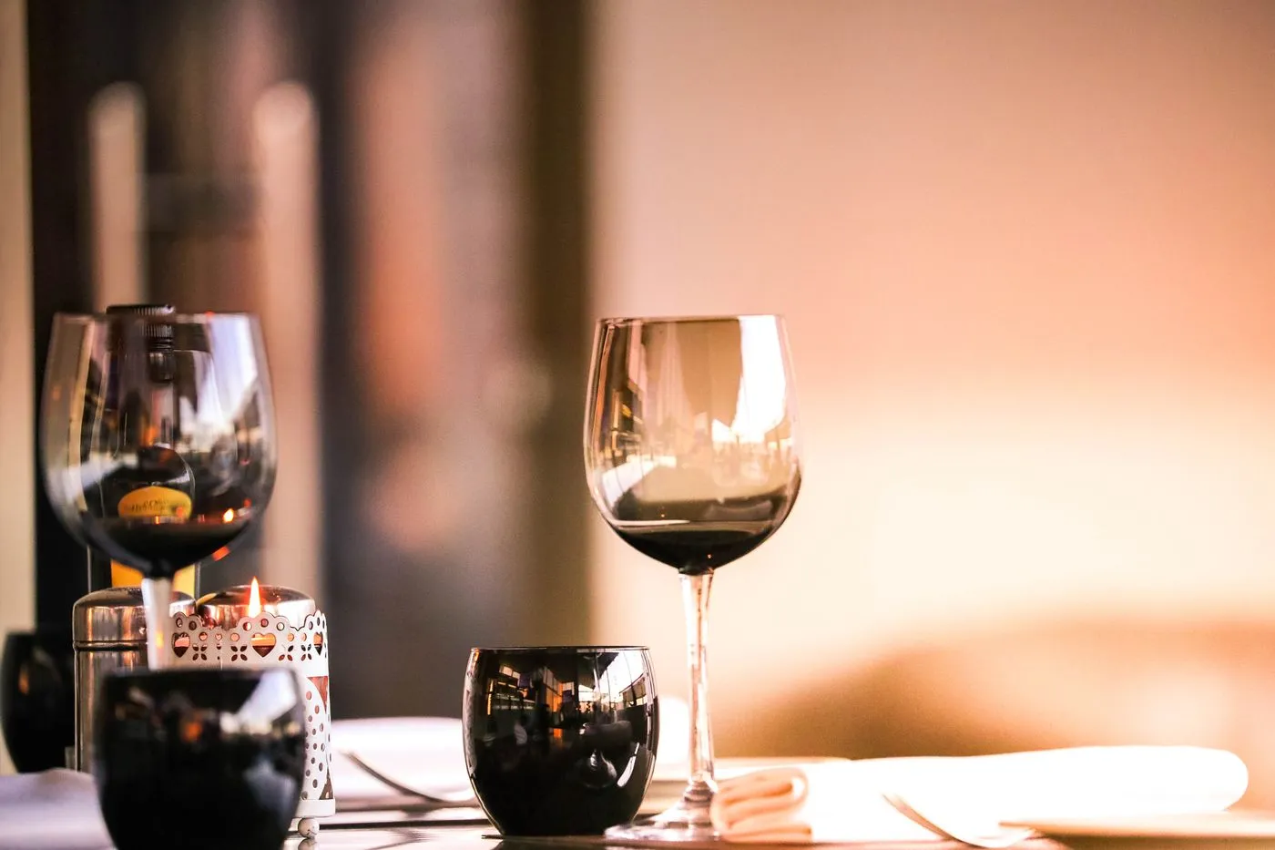 Wine glasses and a candle on a set table