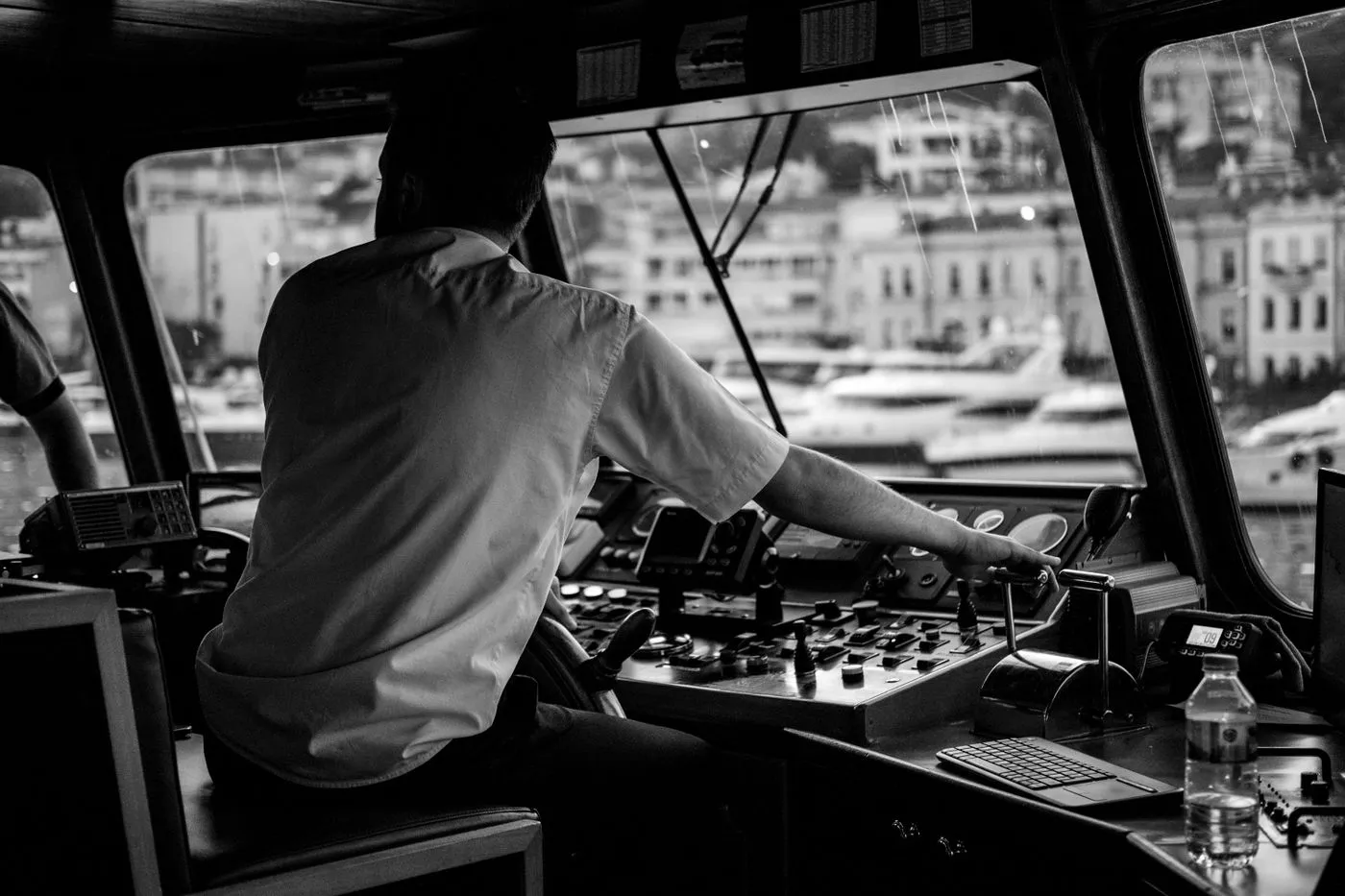 A crew member at the controls of a vessel