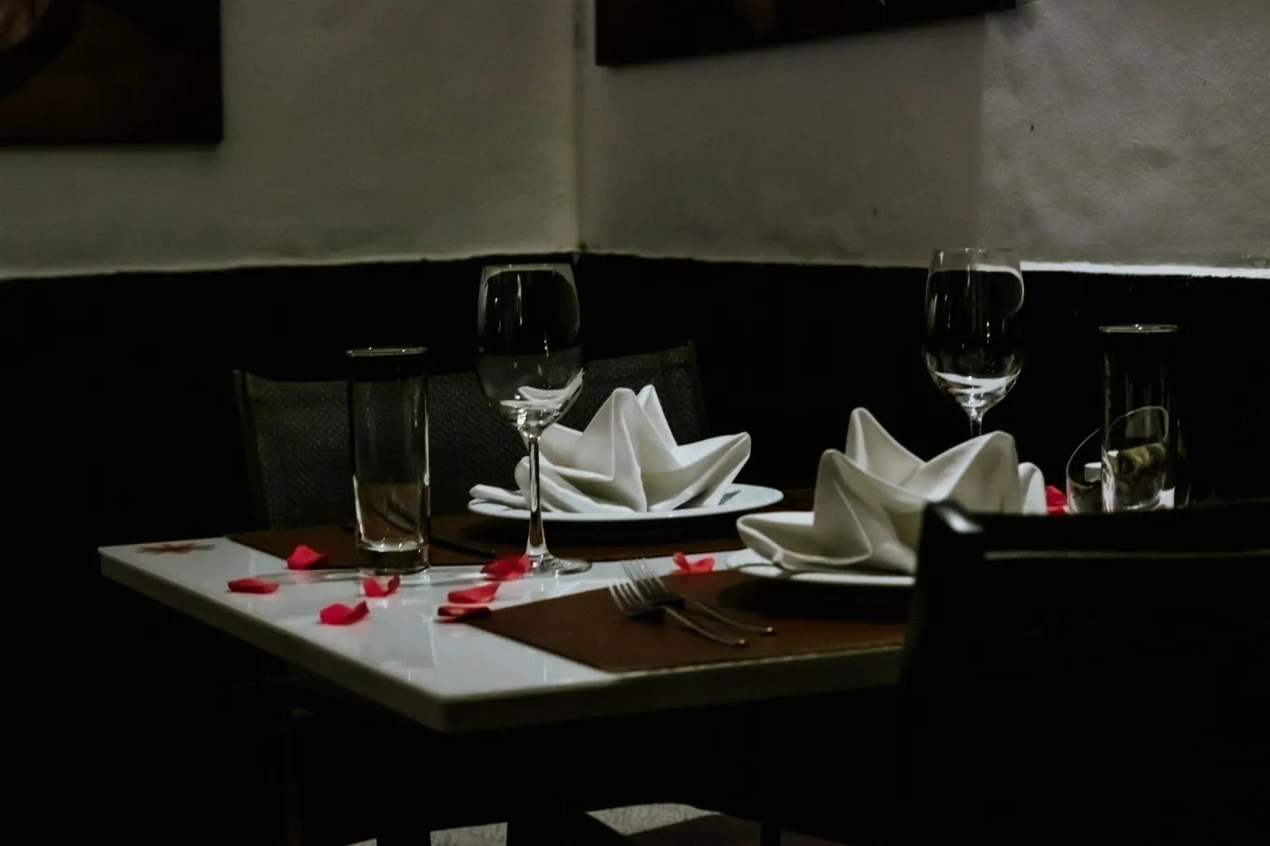 A table set for two with wine glasses at dusk
