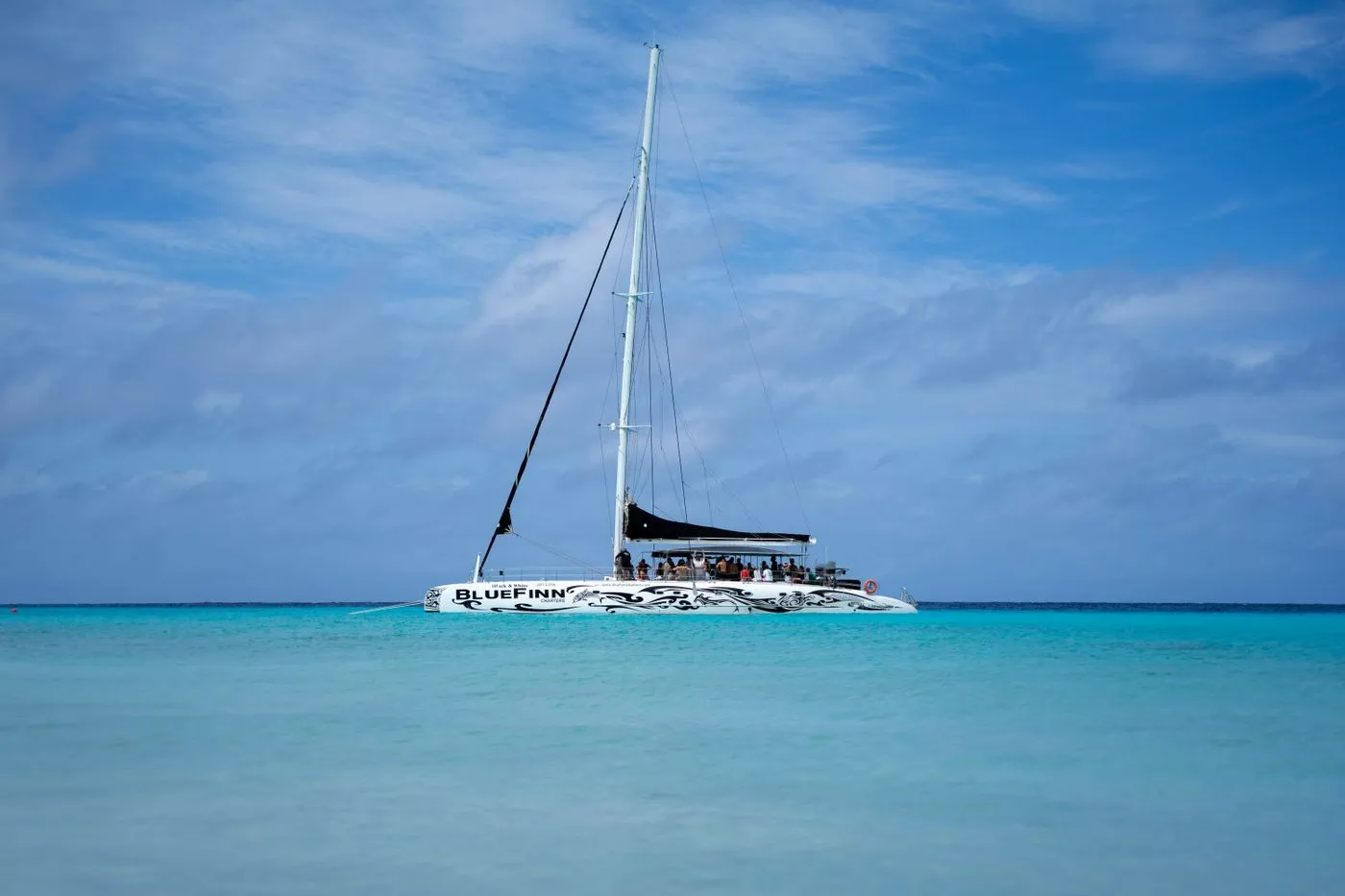 Catamaran on clear turquoise water under a bright sky
