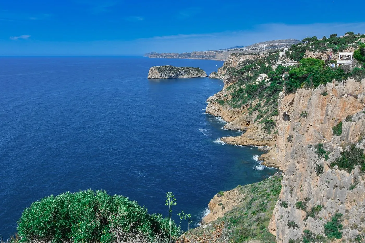 Coastal cliffs above blue water