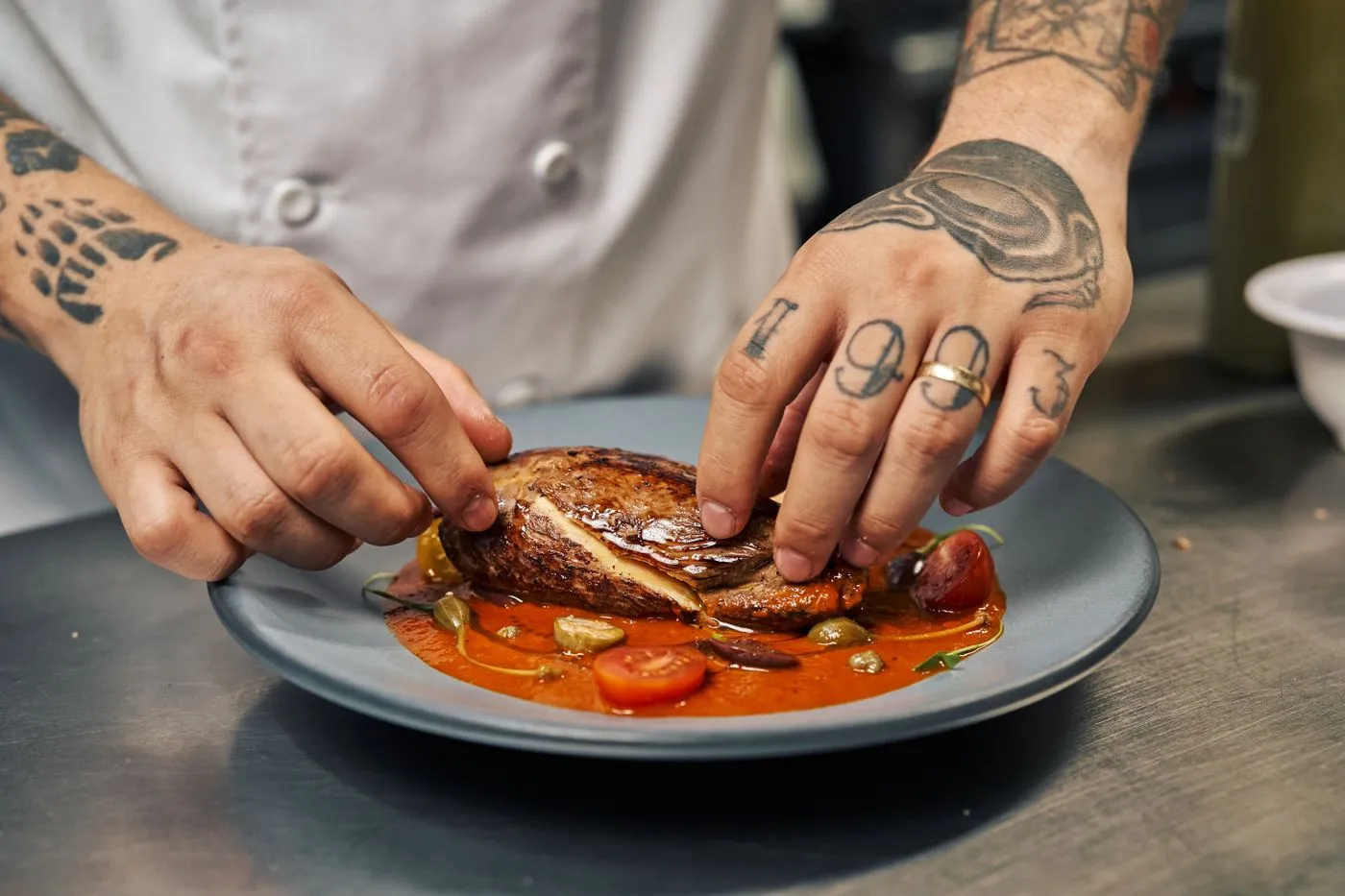 Chef plating a dish in a professional galley