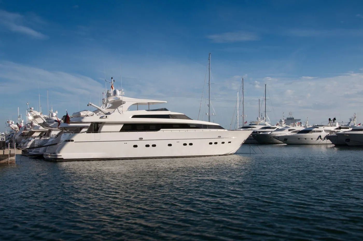Yachts moored in a sunlit Mediterranean marina