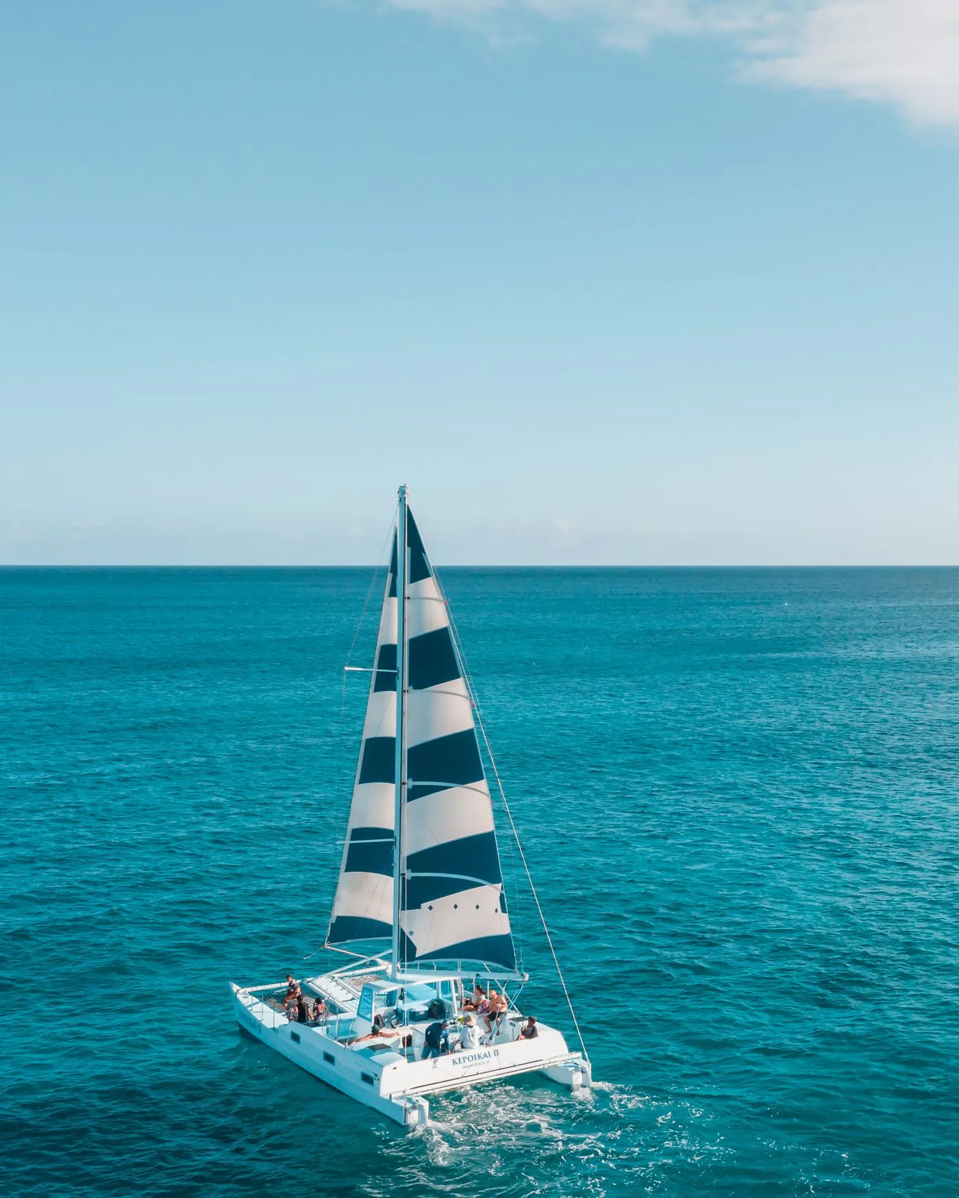 A family aboard a sailing boat on calm water