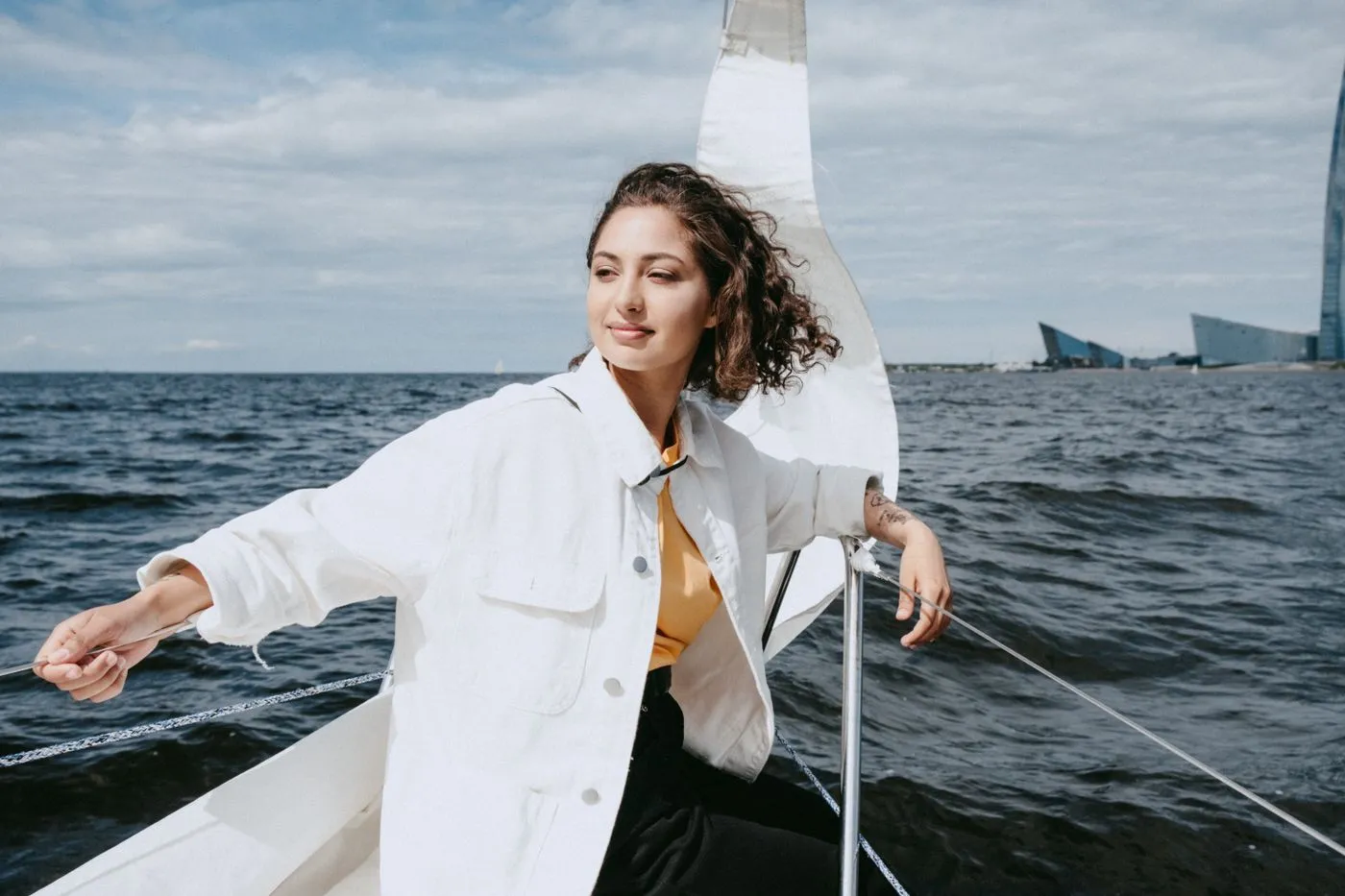 A guest sailing on a yacht on a calm, bright day