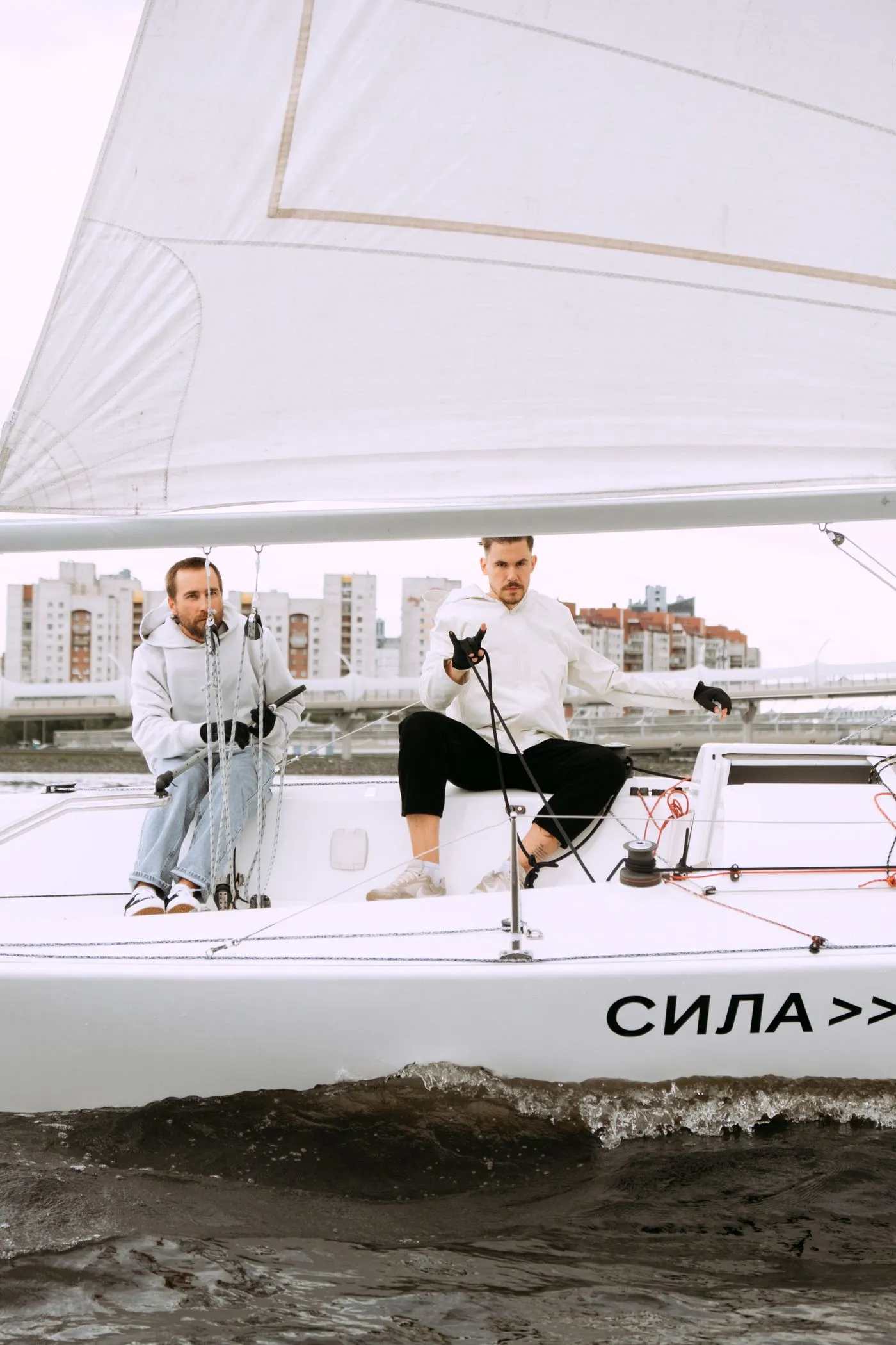 Two crew sailing a yacht on open water