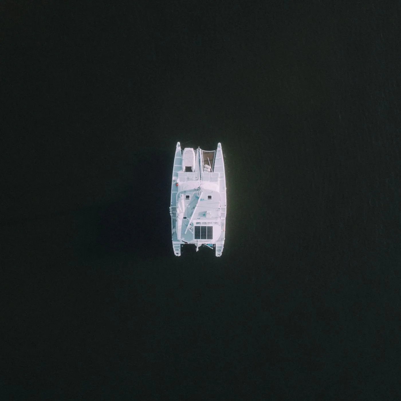 Overhead view of a catamaran on calm tropical water