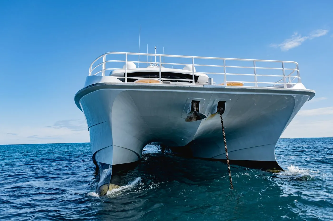 Luxury catamaran at anchor on calm water