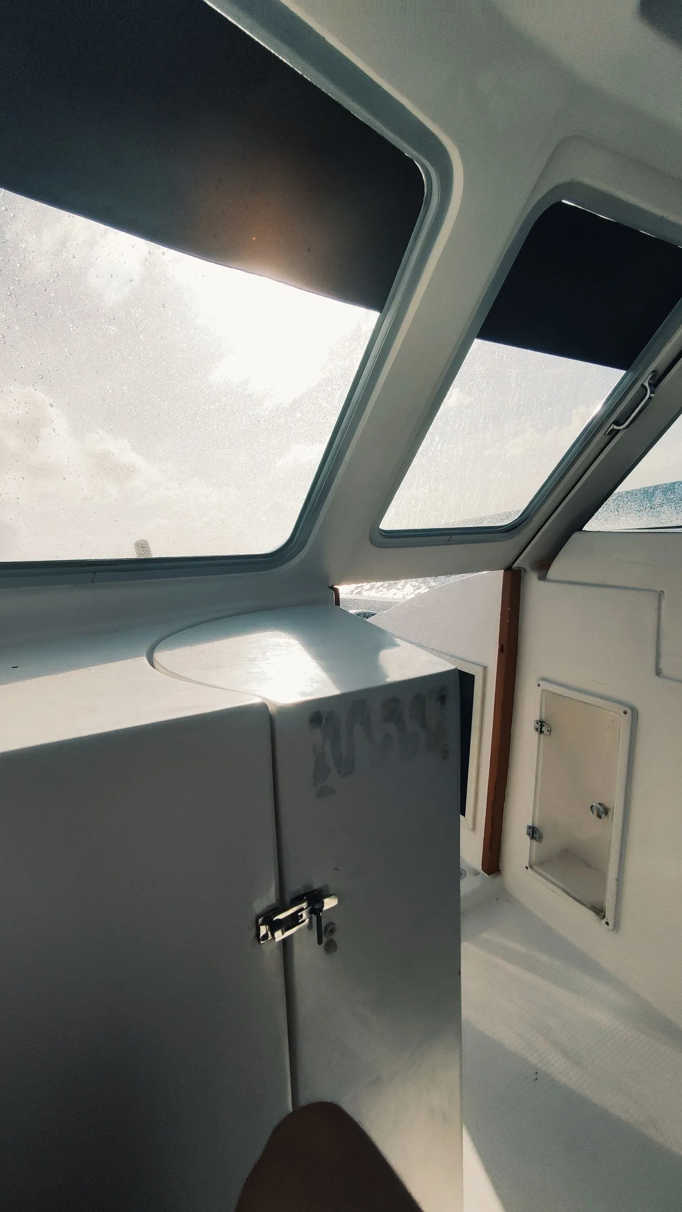 Sunlit yacht cabin interior with linen bedding